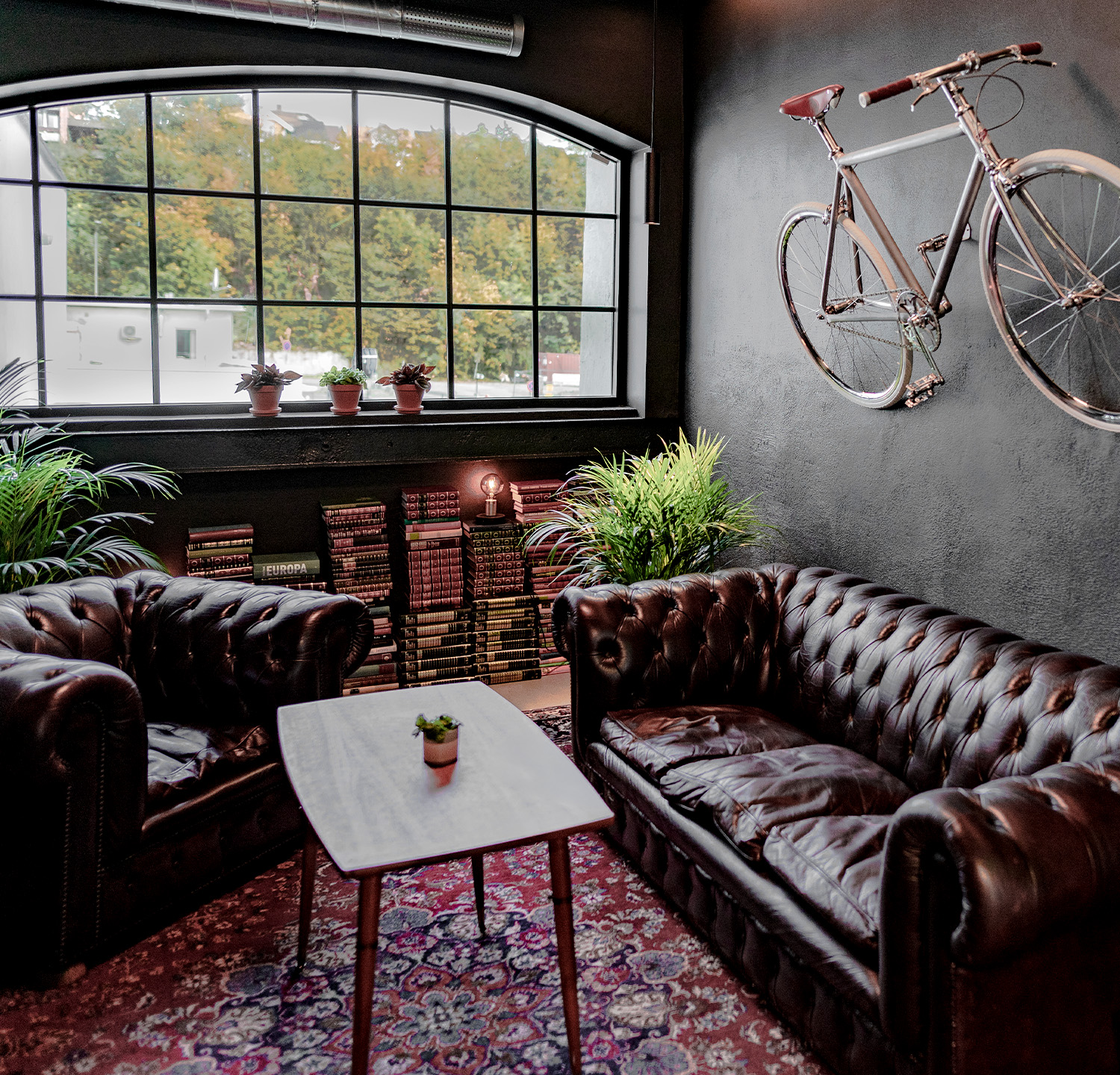 Room with two sofas in Brooklyn style environment and a bike on the wall