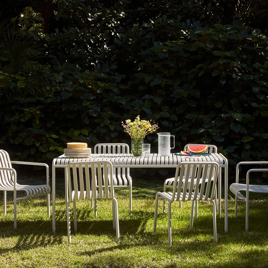 Sky grey chairs and table from the Palissade collection in a garden.