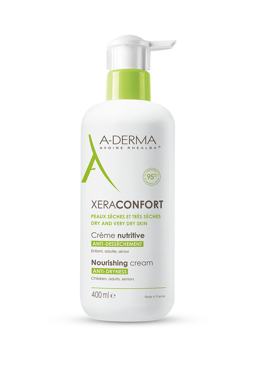 Et produktbilde av A-Derma XeraConfort Nourishing Cream i en hvit flaske med grønn pumpe. Kremen er designet for tørr og svært tørr hud, og er egnet for både barn og voksne. Flasken inneholder 400 ml og er merket som en fuktighetsgivende og anti-tørrhetskrem