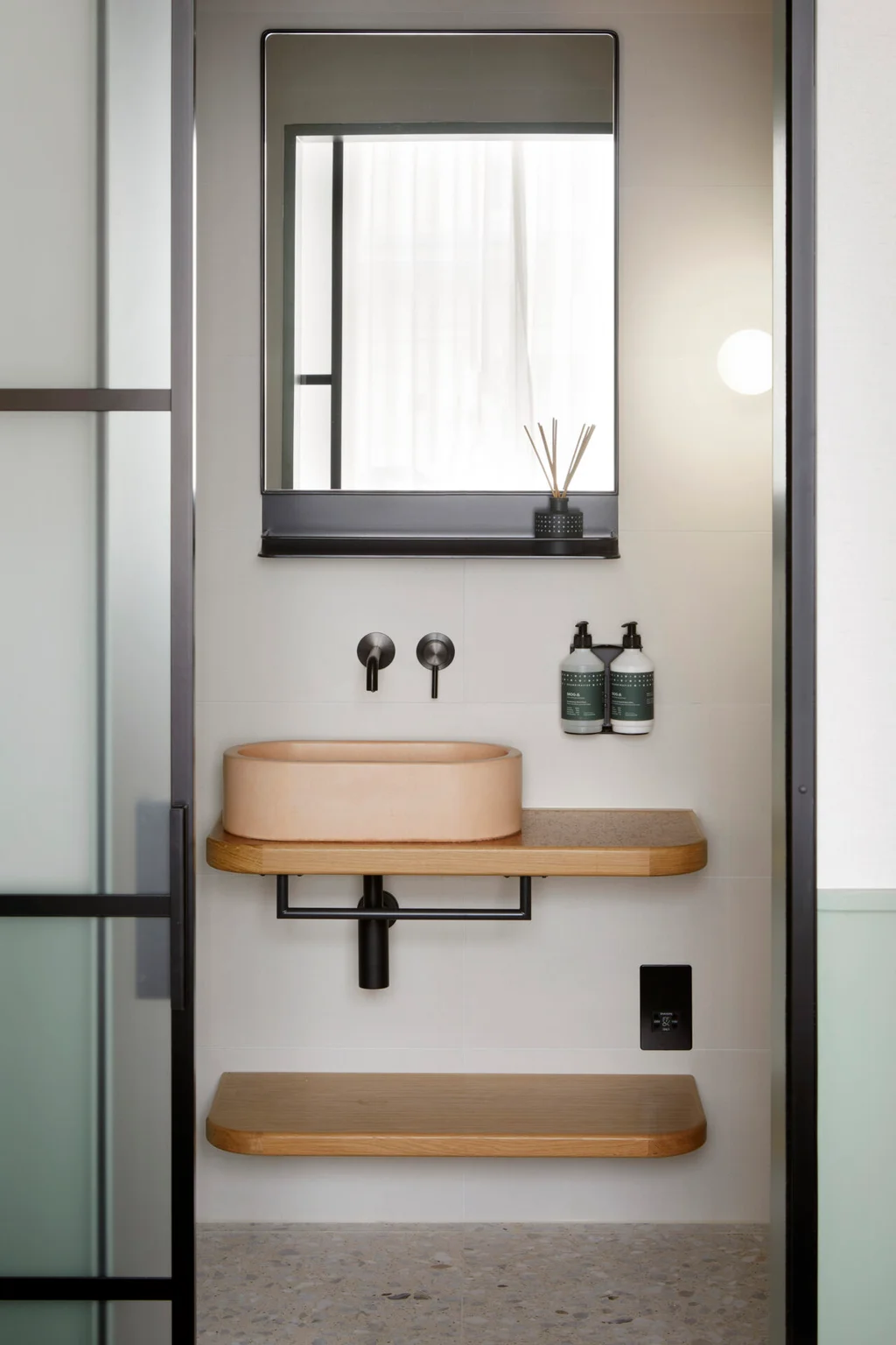 inhabit sustainable bathroom with wall mounted dispenser