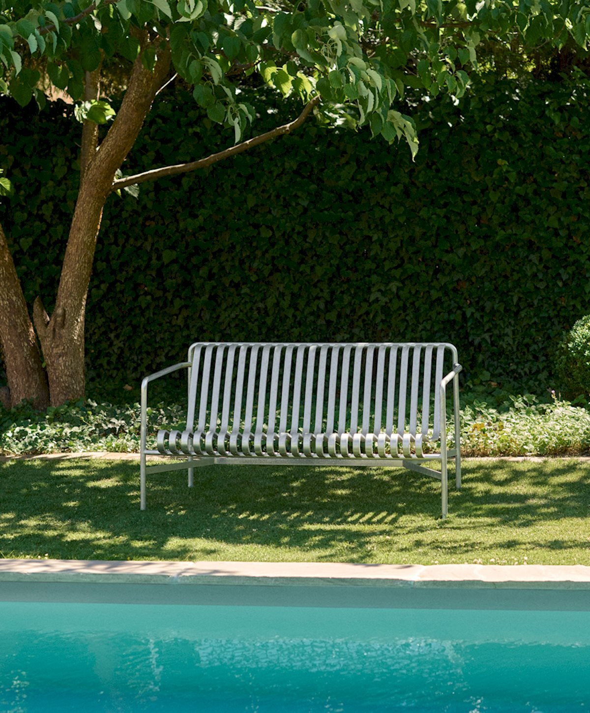Sky grey Palissade lounge sofa on a pool deck