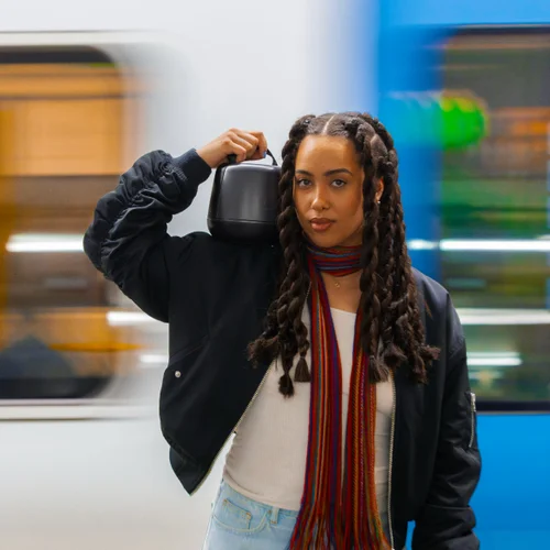 Person carrying the Nomono Sound Capsule — portable recording anywhere