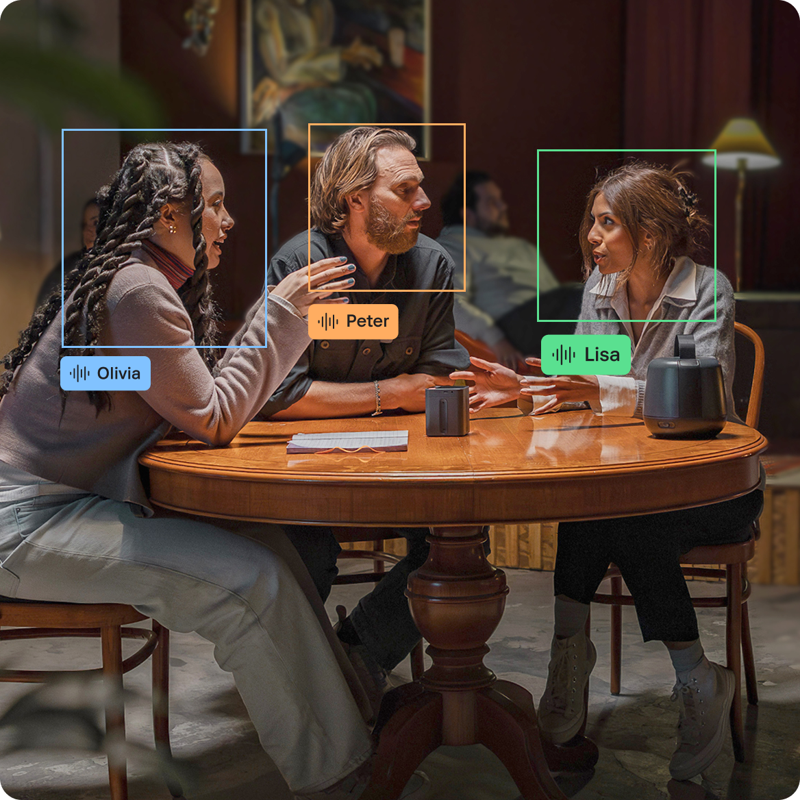 People talking together in an loud open space with graphics showing their names and where the sound is focused