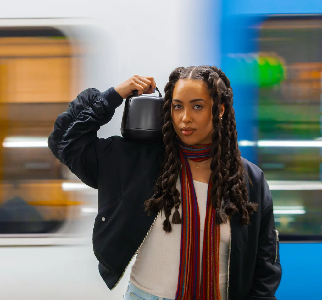 Person carrying the Nomono Sound Capsule — portable recording anywhere