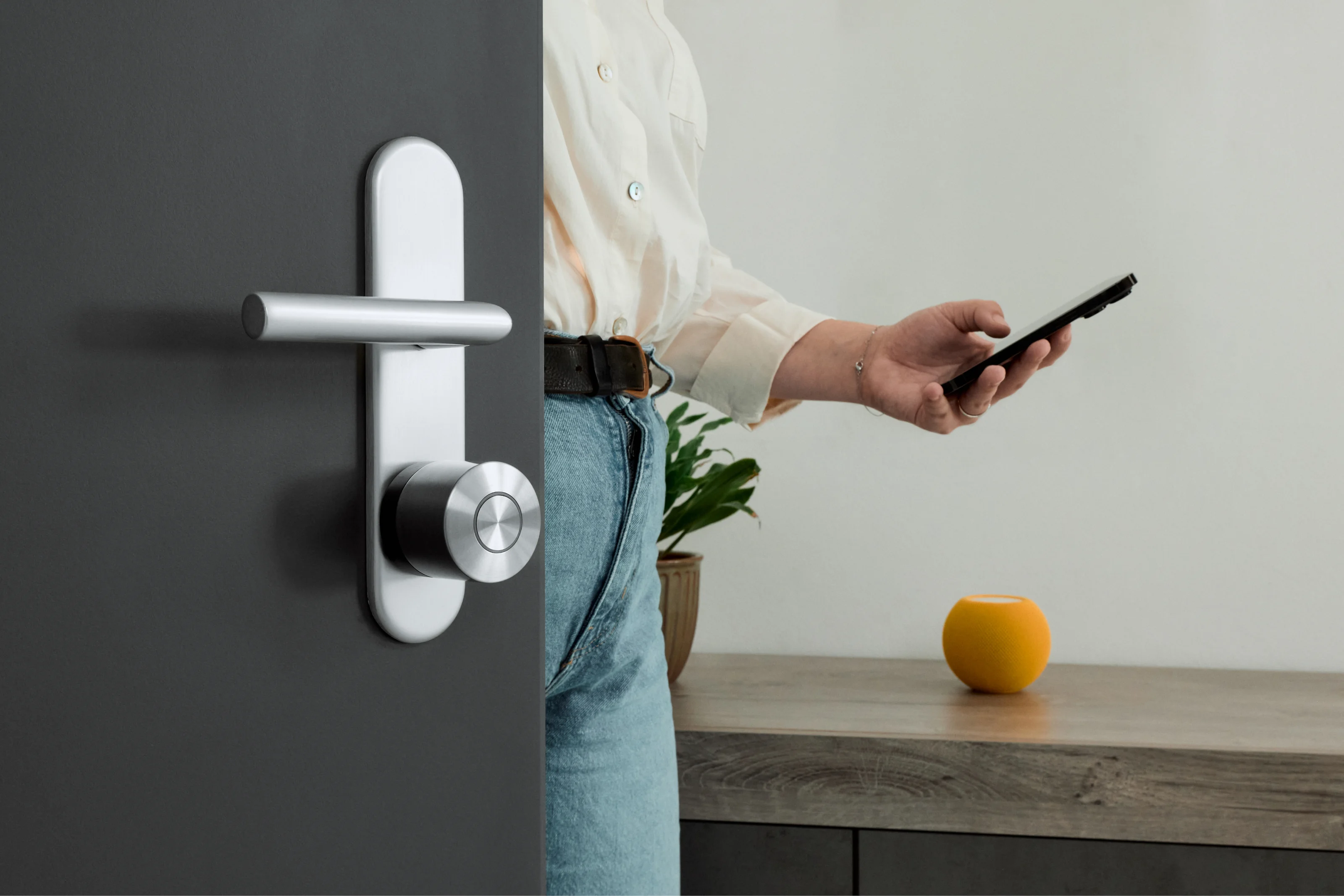 Person unlocking a door with the Smart Lock Ultra using a smartphone