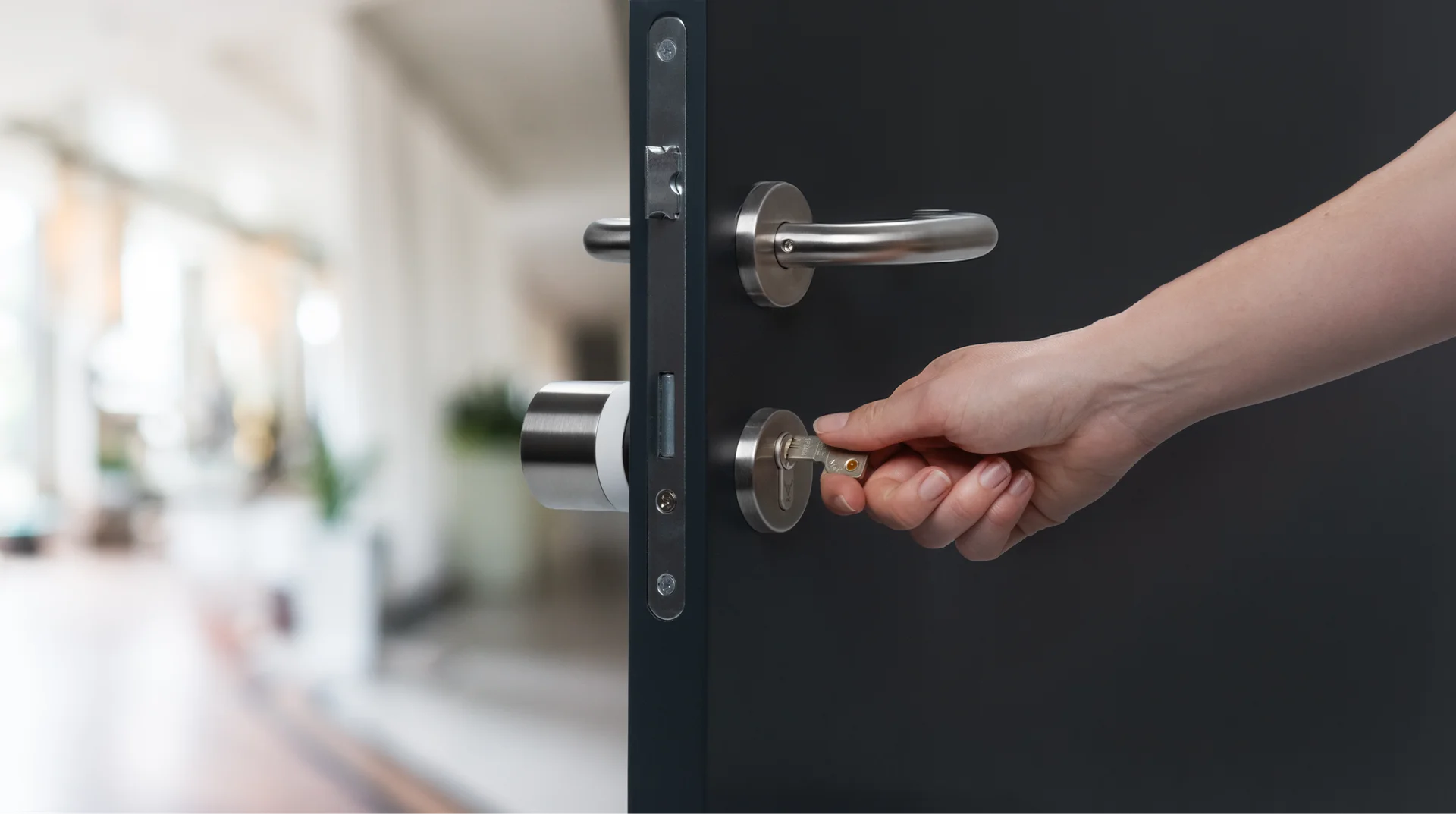 Hand inserting key into door with Nuki Smart Lock.