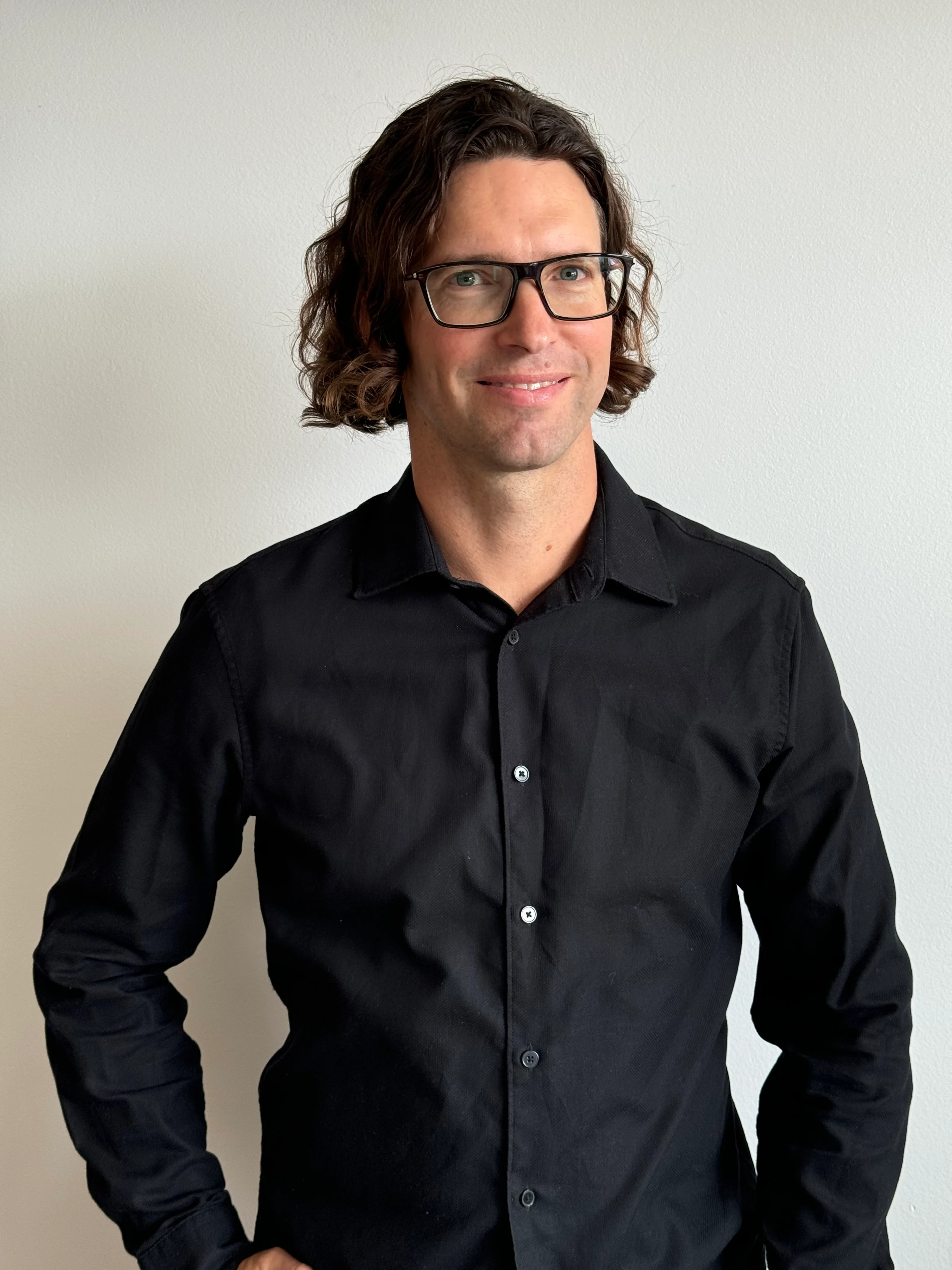 Matjaž Križmančič, Director of MAVE d.o.o., standing and smiling in front of a plain white background.
