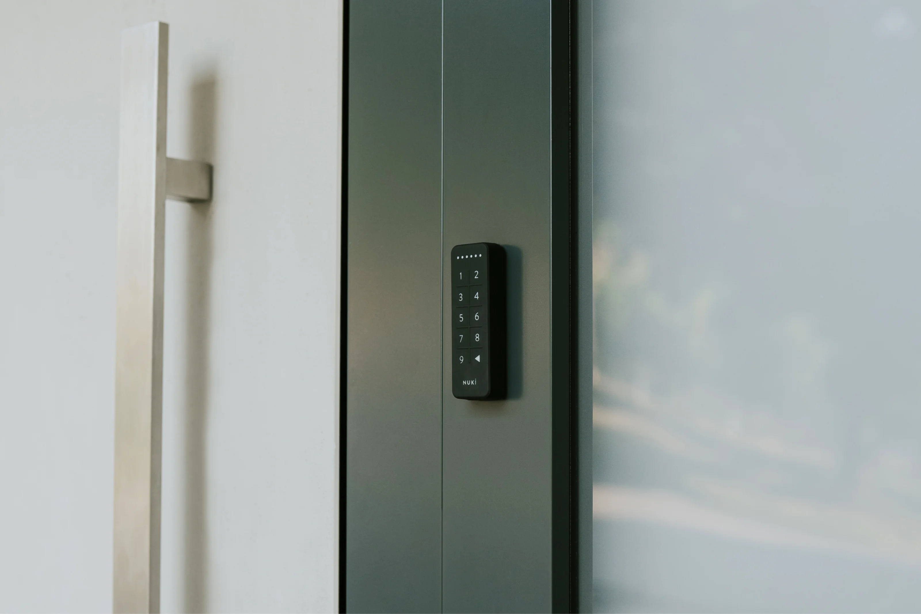 Nuki Keypad mounted beside a modern front door for keyless access