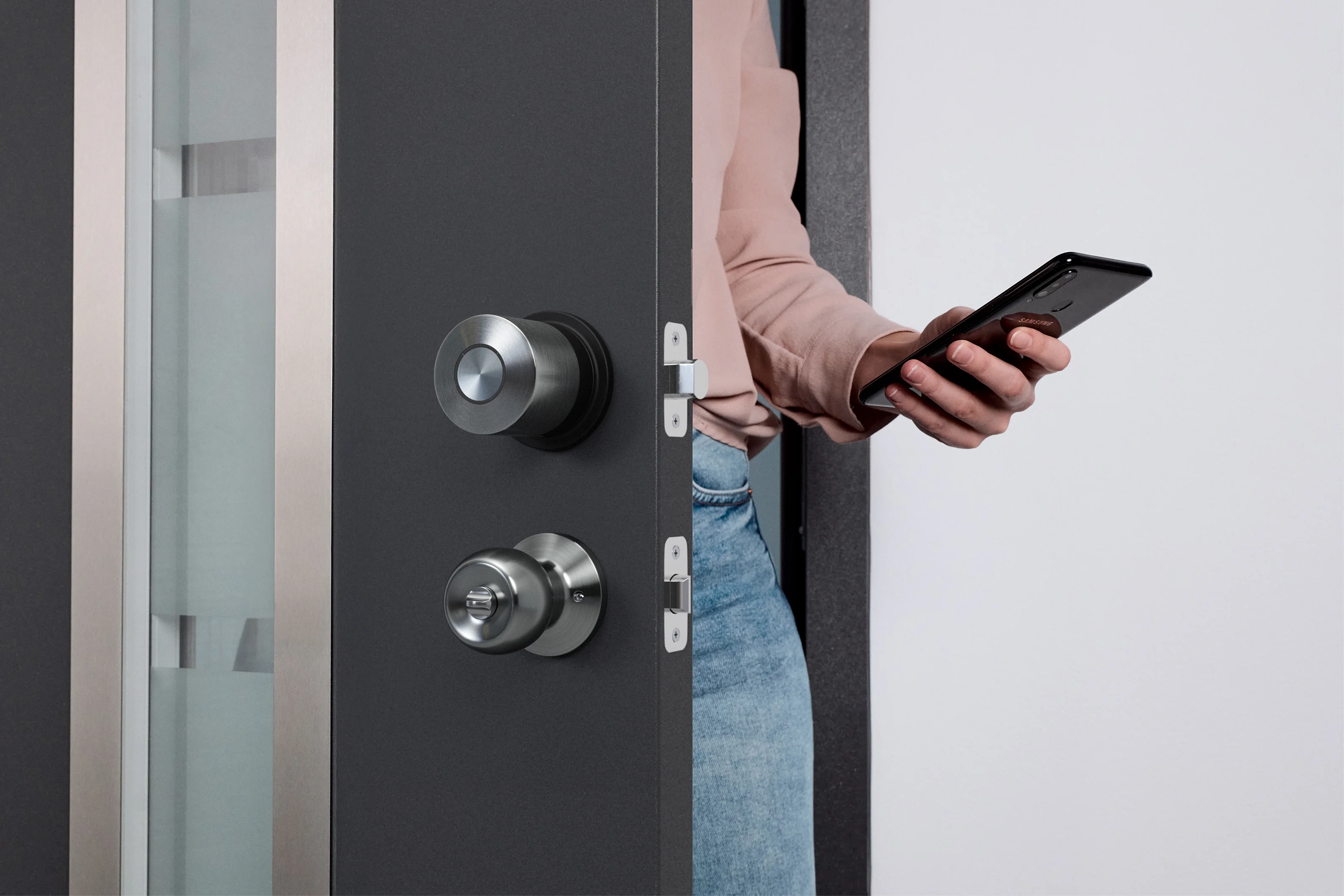 Person unlocking the door with a smartphone using the Smart Lock