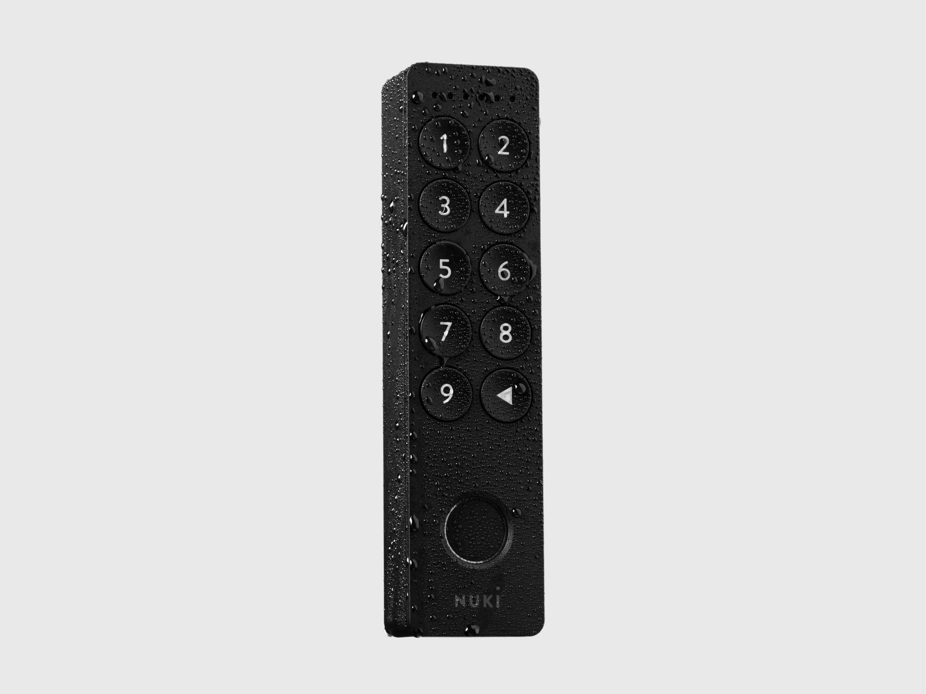 Nuki Keypad 2 covered in water droplets, highlighting its weatherproof design.