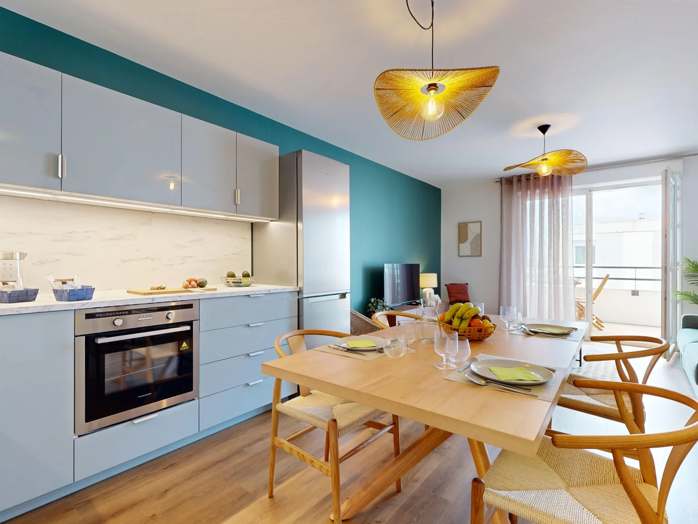 The dining room and kitchen in an appartment with stylish interior design. Held in white and wood.