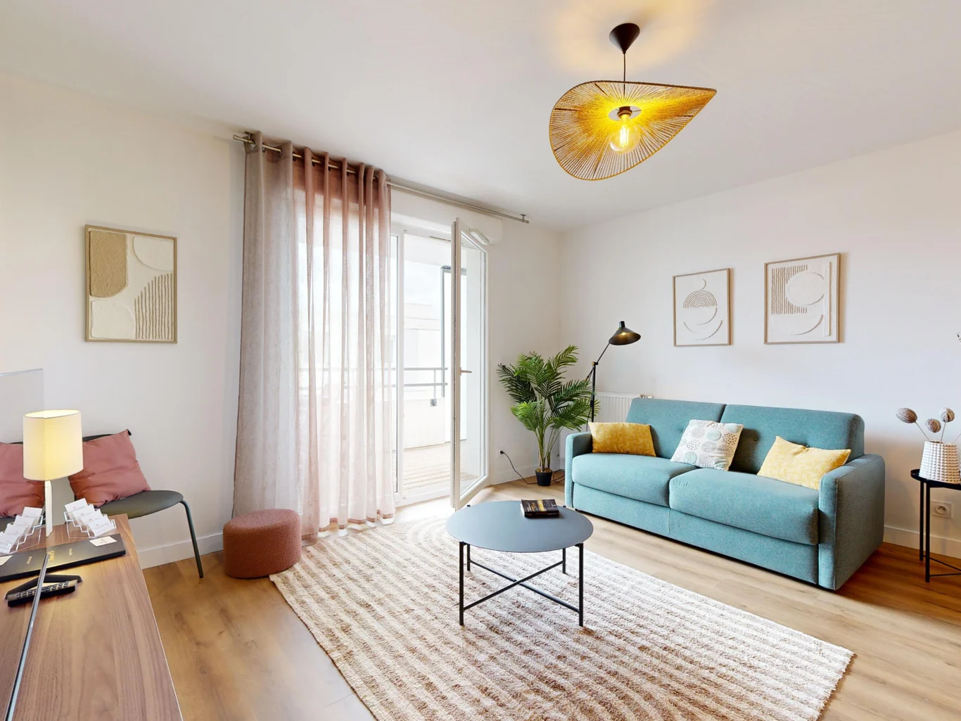 The living room in an appartment with stylish interior design. Held in warm tones with a turquoise couch.