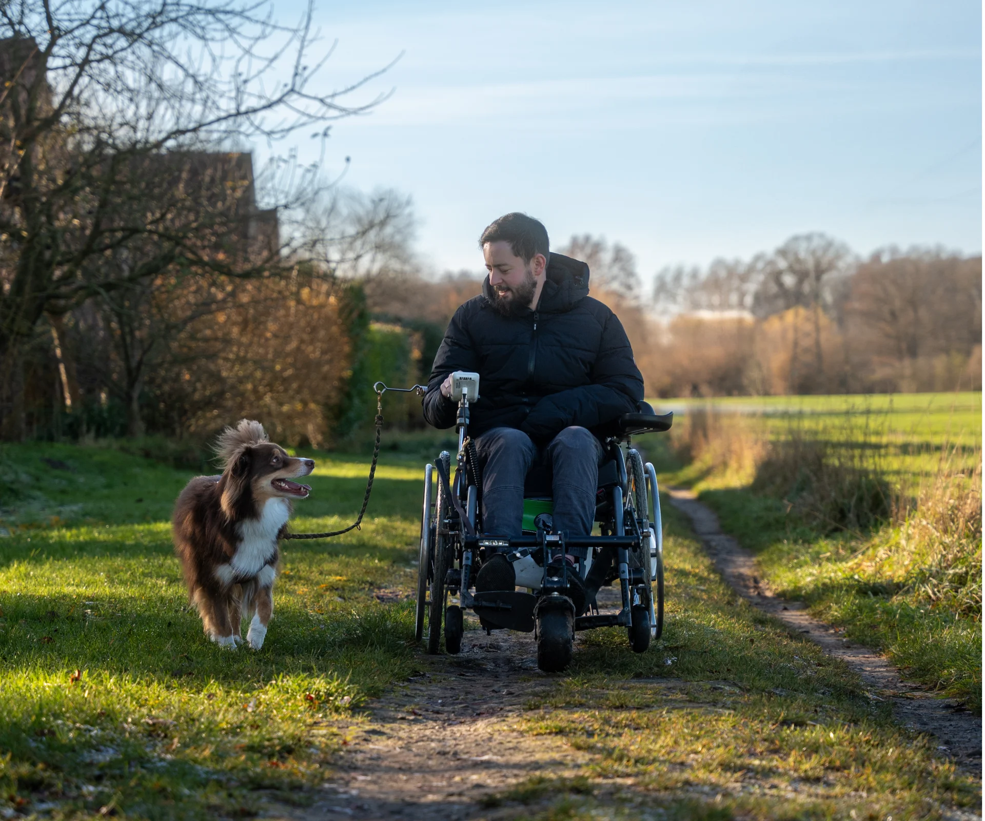 Timo Stiehl in a wheelchair walking with his dog Nemo