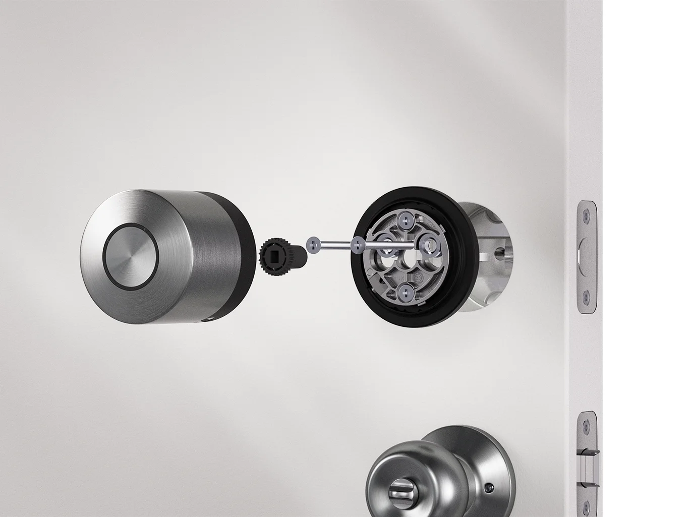 Installation of the Smart Lock US on the door’s inside. Door handle, mounting plate, adapter and smart lock are visible.