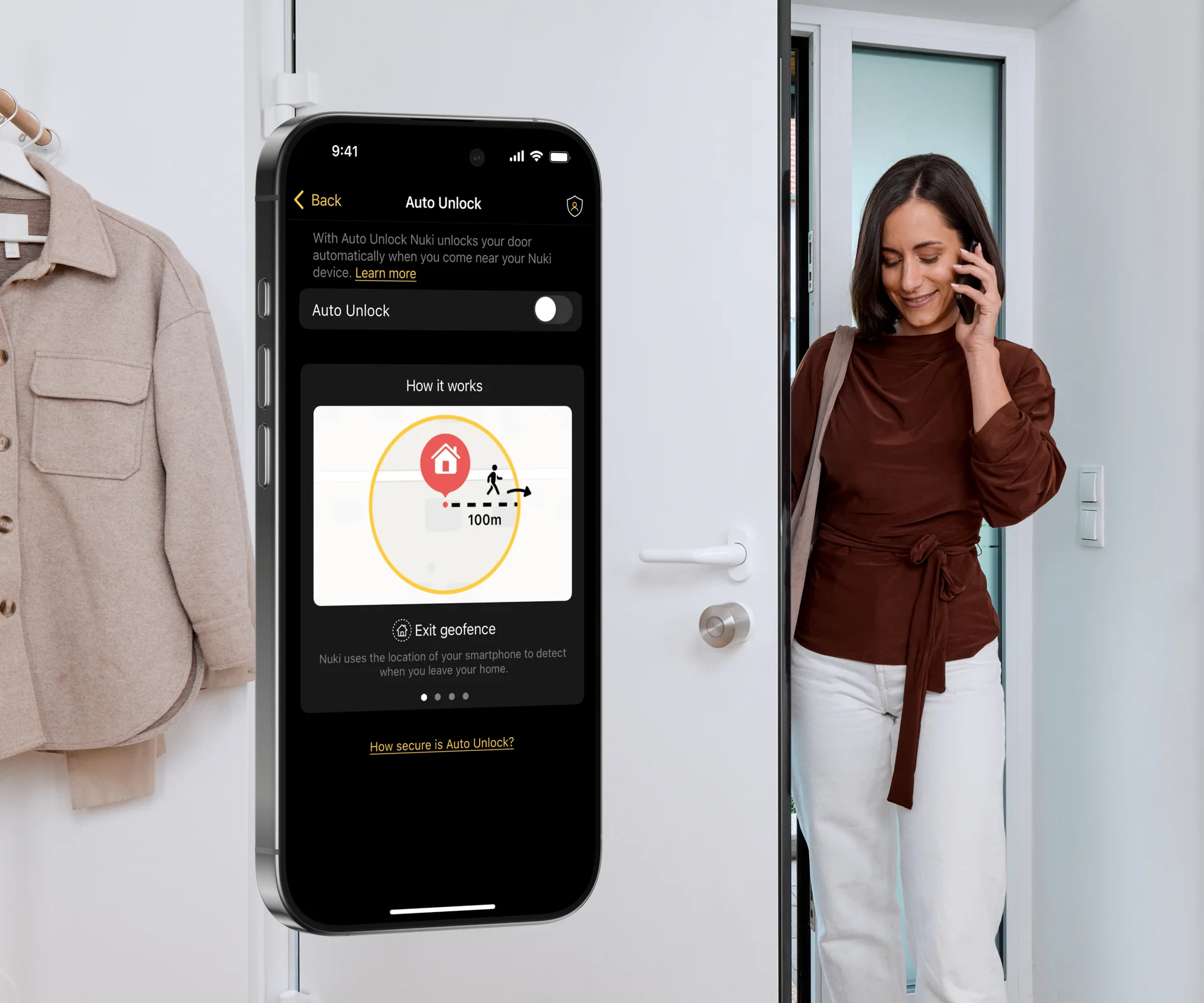 A woman enters through the front door. The Smart Lock is mounted on the inside of the door. The Nuki app with the Auto Unlock settings is visible on a smartphone.