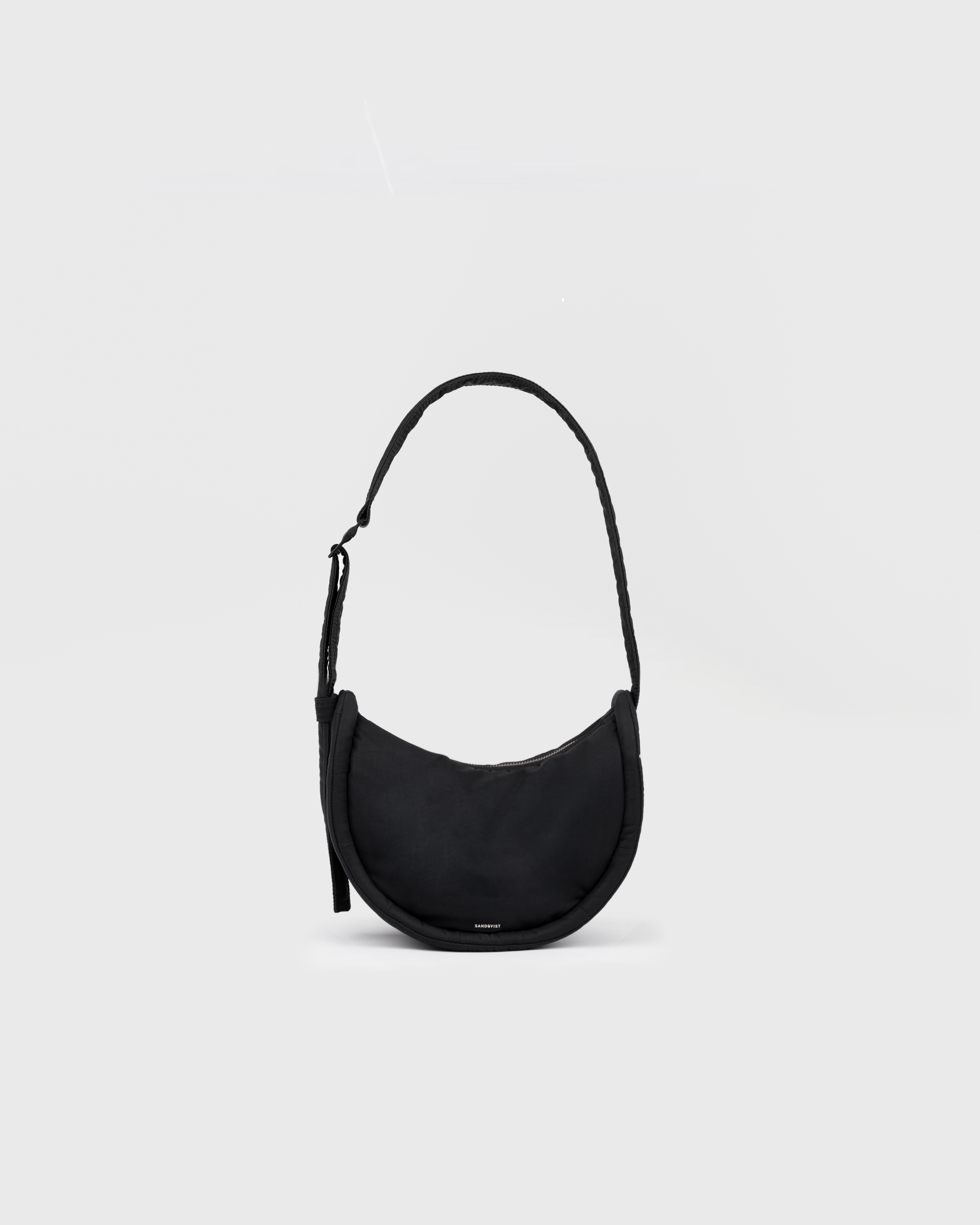 Handbag. Sandqvist Curve Half Moon Bag Mini, black. Front view with shoulder strap.