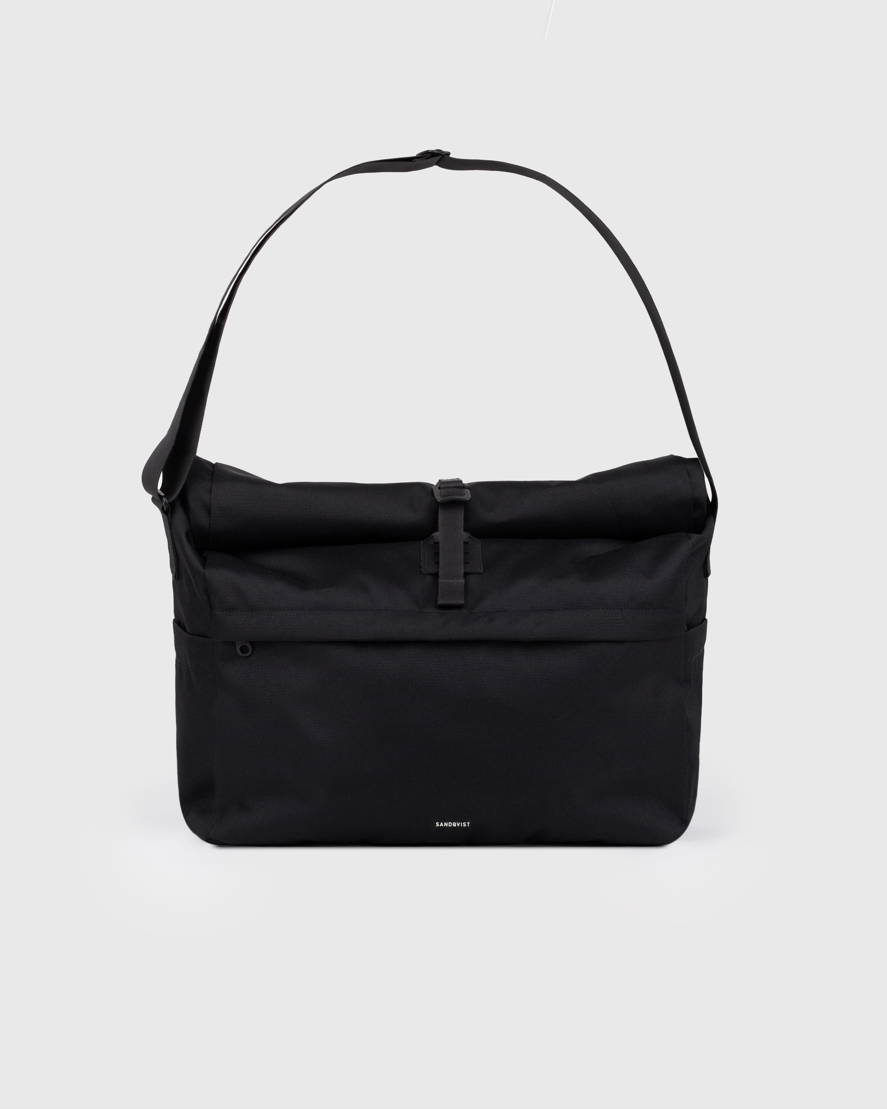 Sandqvist Icon Messenger Bag, black. Front view, buckle and shoulder strap.