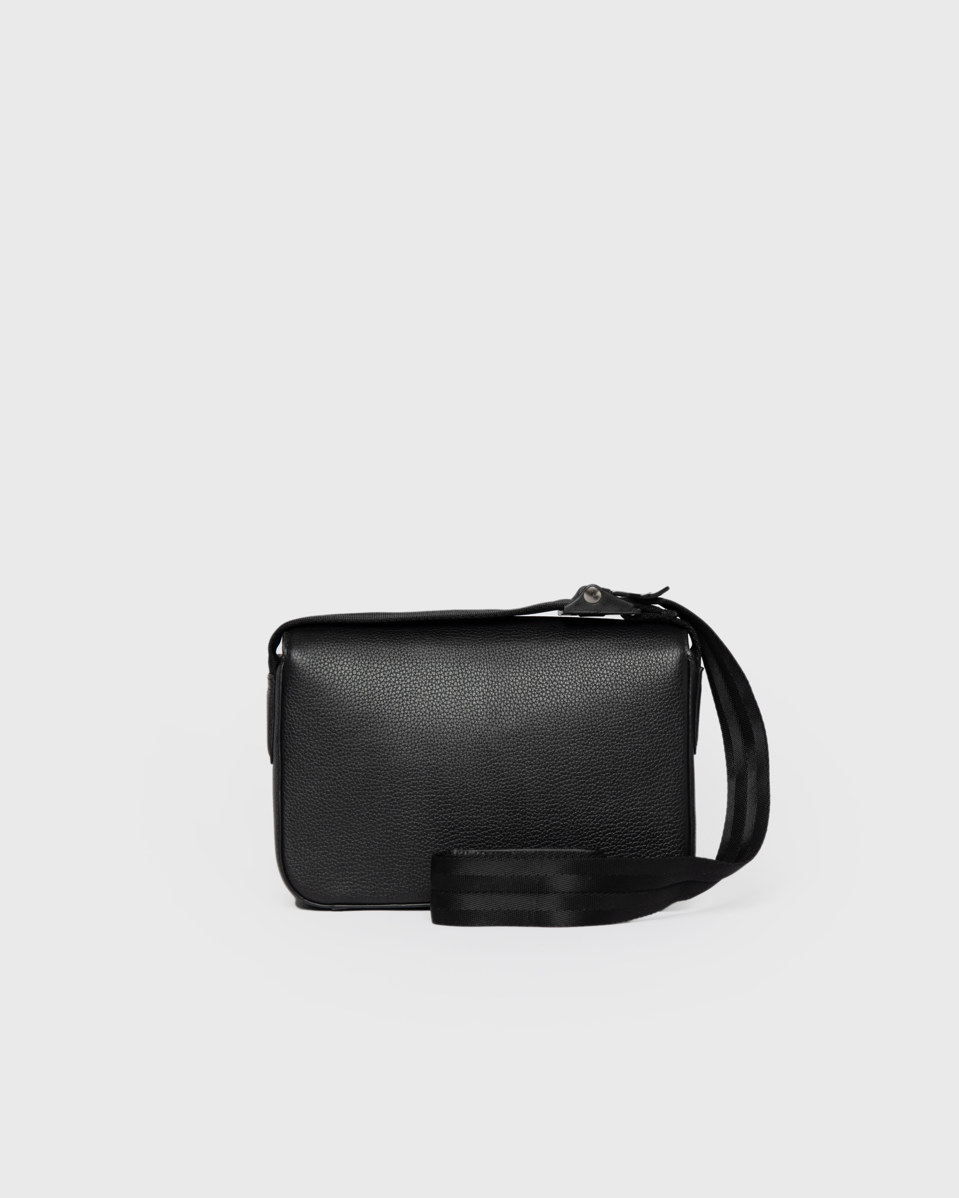 Front view of the bag Sandqvist Agile Crossbody Bag, black, with the strap showing in the front.
