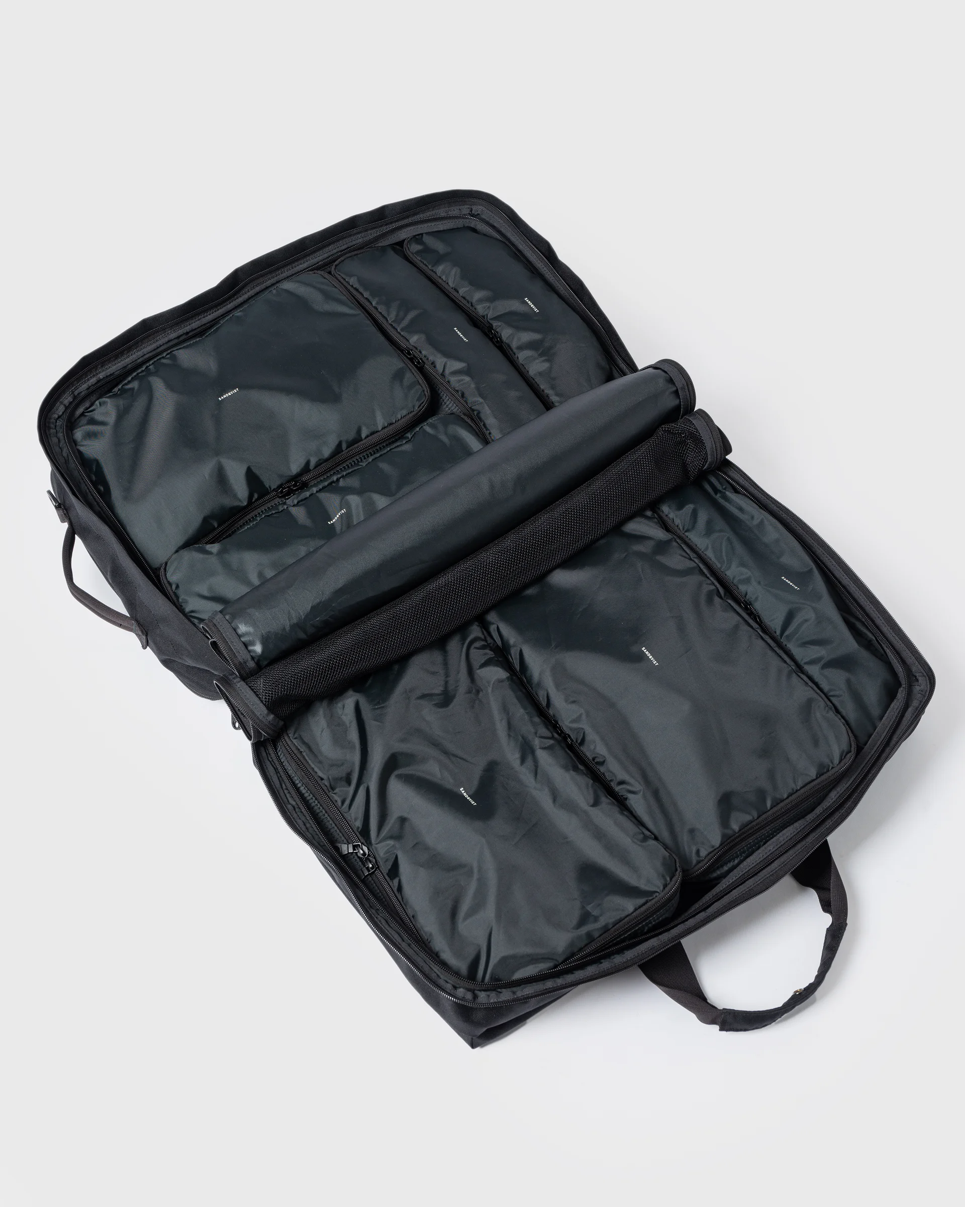 Sandqvist GO 3-way Bag M fully opened. Top view showing the bag filled with four packing cubes on one side and three packing cubes on the other side.