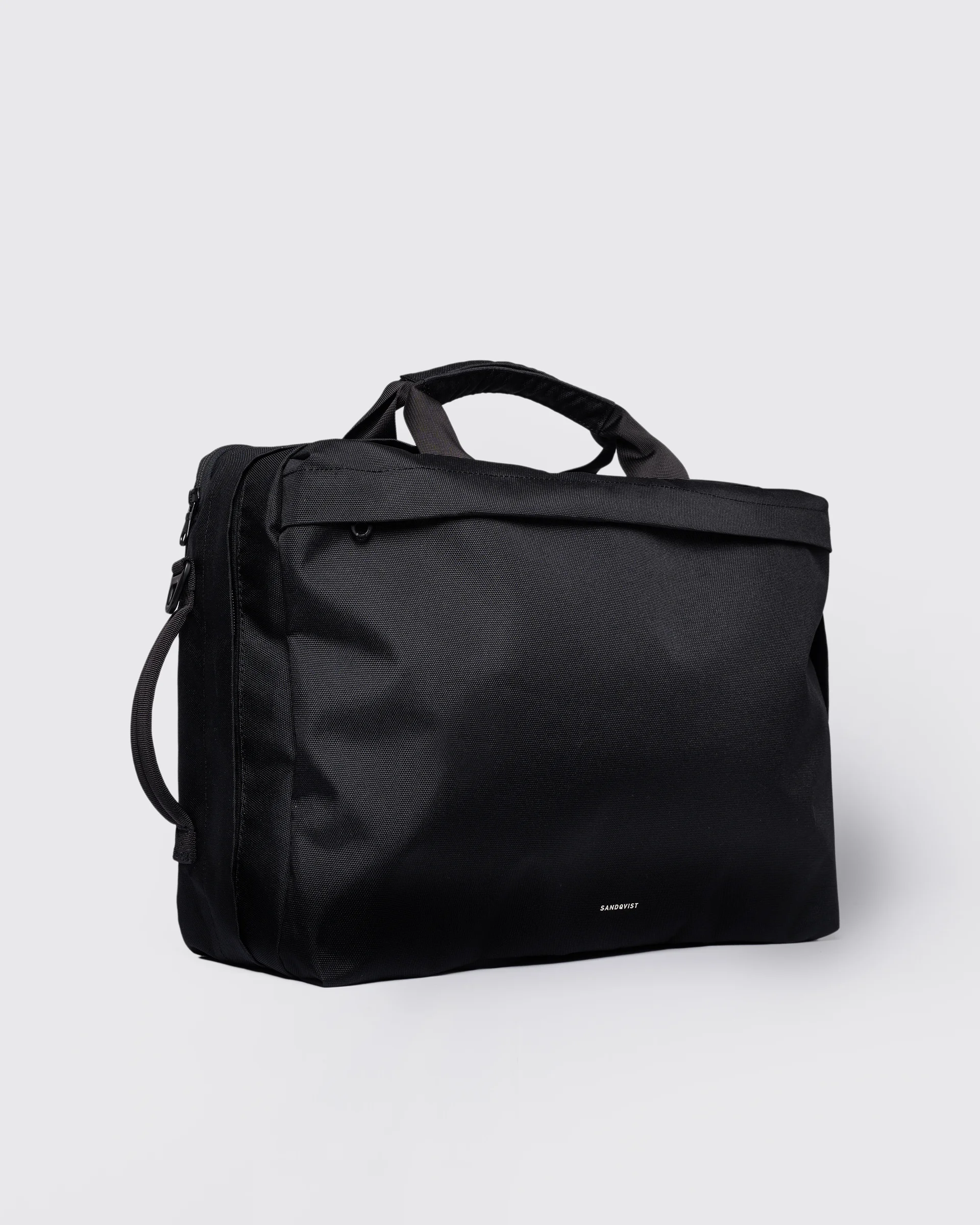 GO 3-Way Bag M, black. Front view, two top-handles and one on the side.