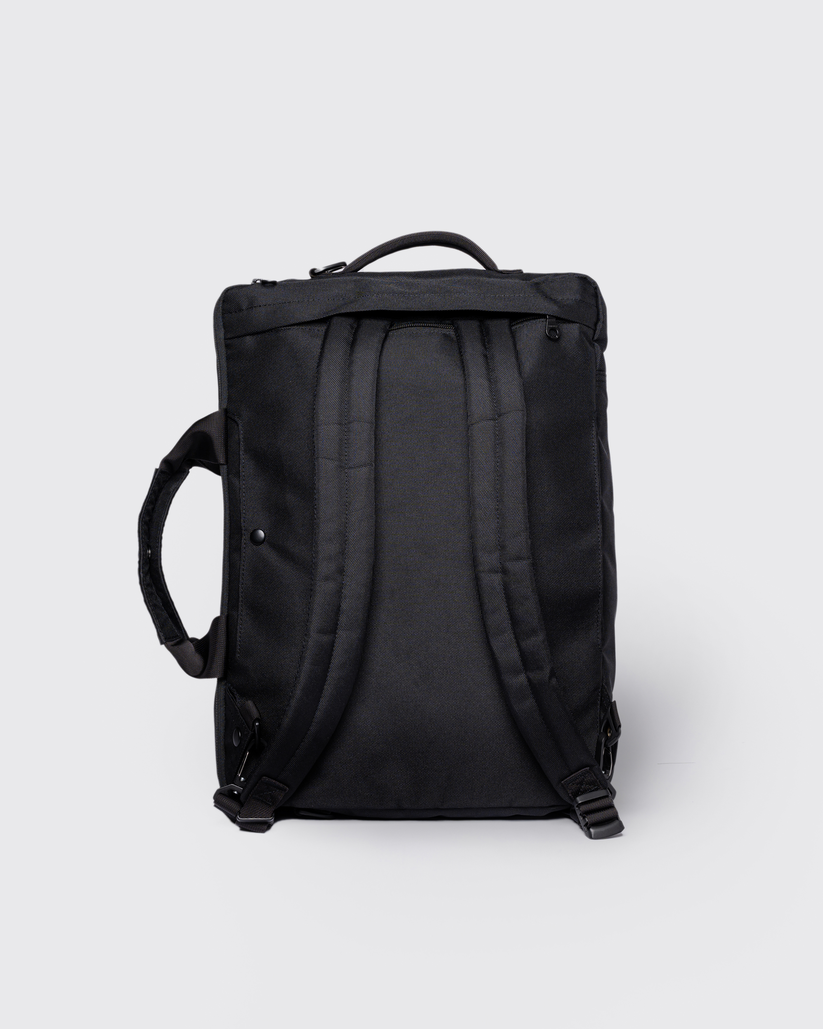 GO 3-Way Bag M, black. Back view, two handles and shoulder straps.