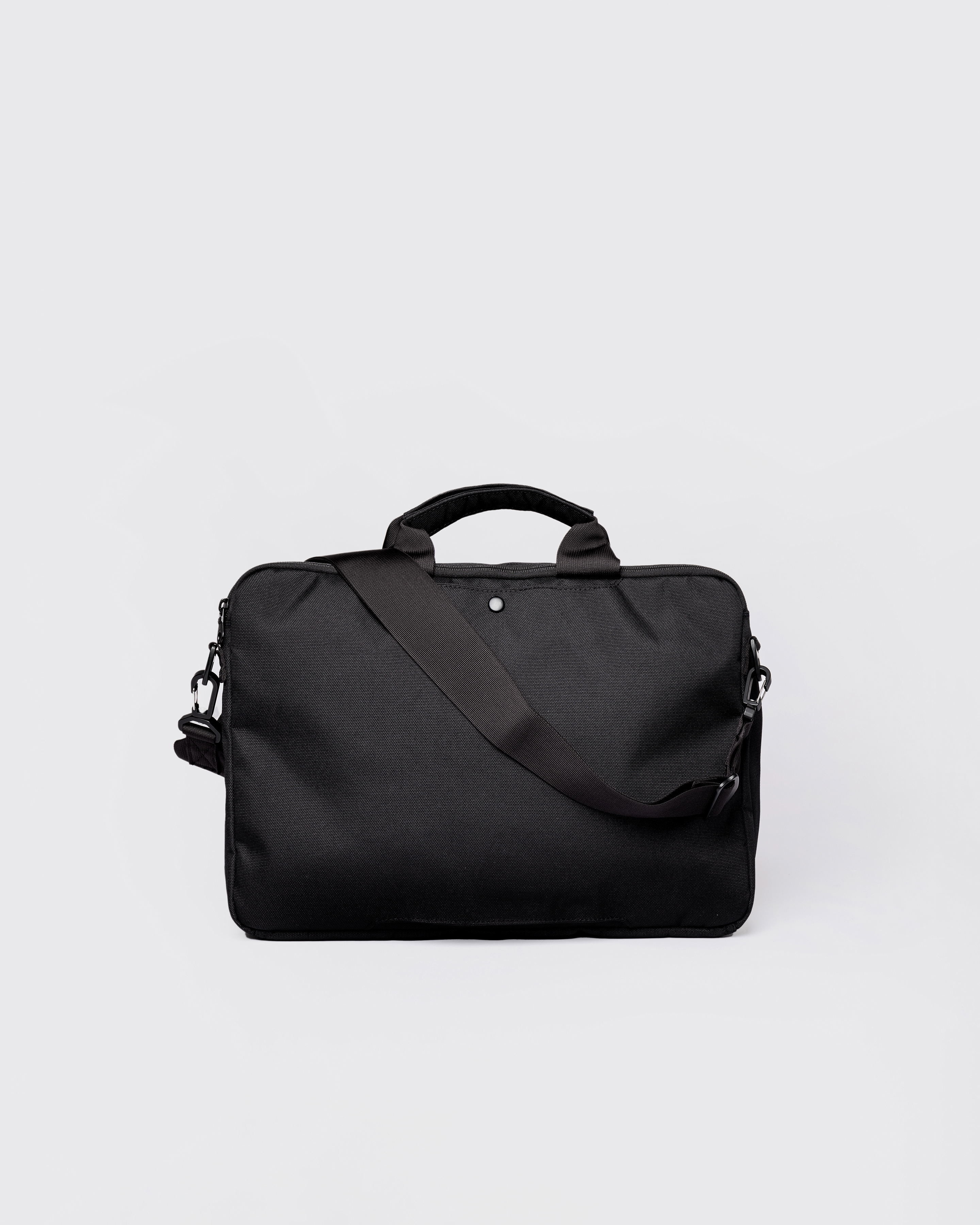 GO Briefcase, black. Back view, top handles and shoulder strap.
