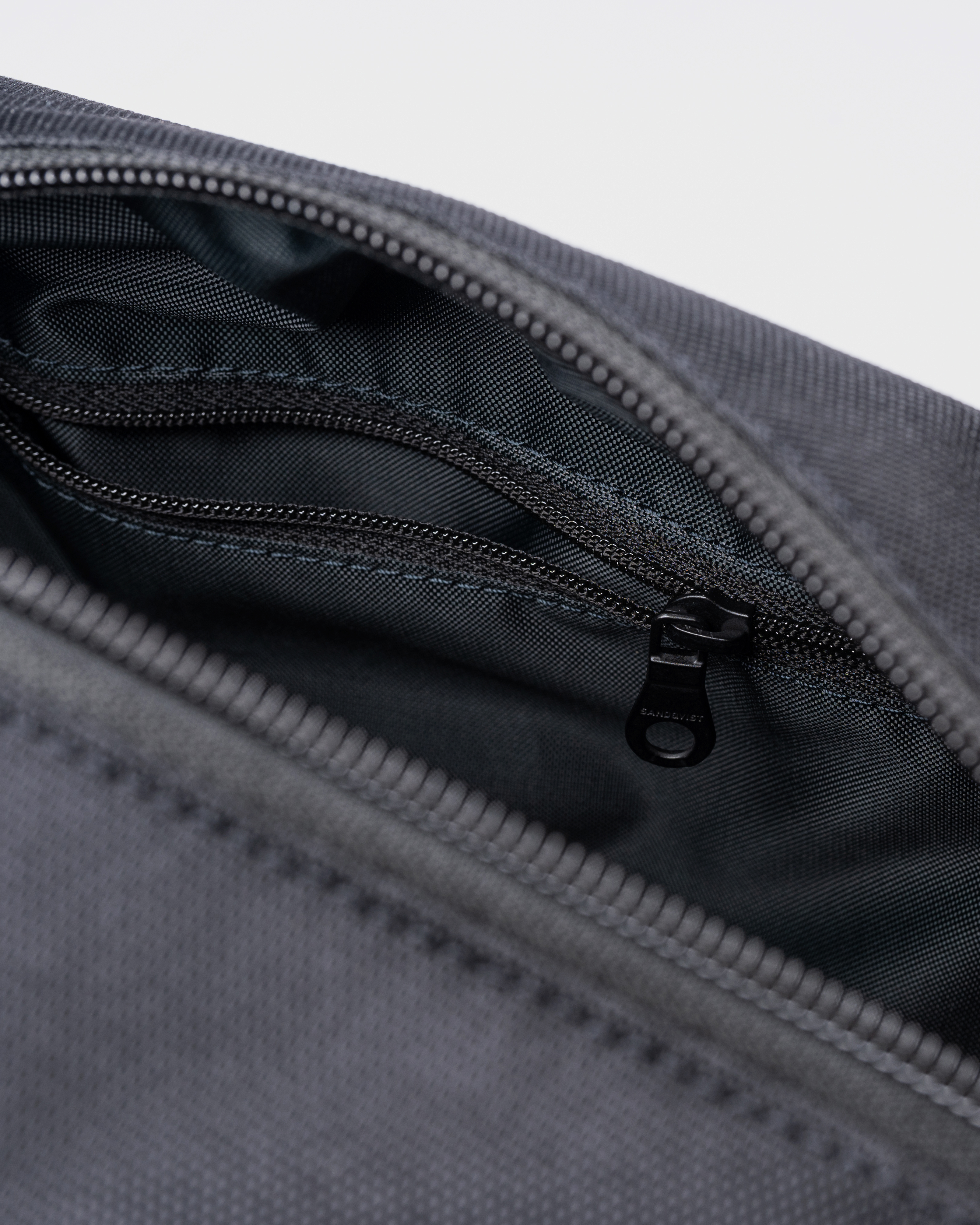 GO Handle Wash Bag, black. Inside view, inner zipper pocket.