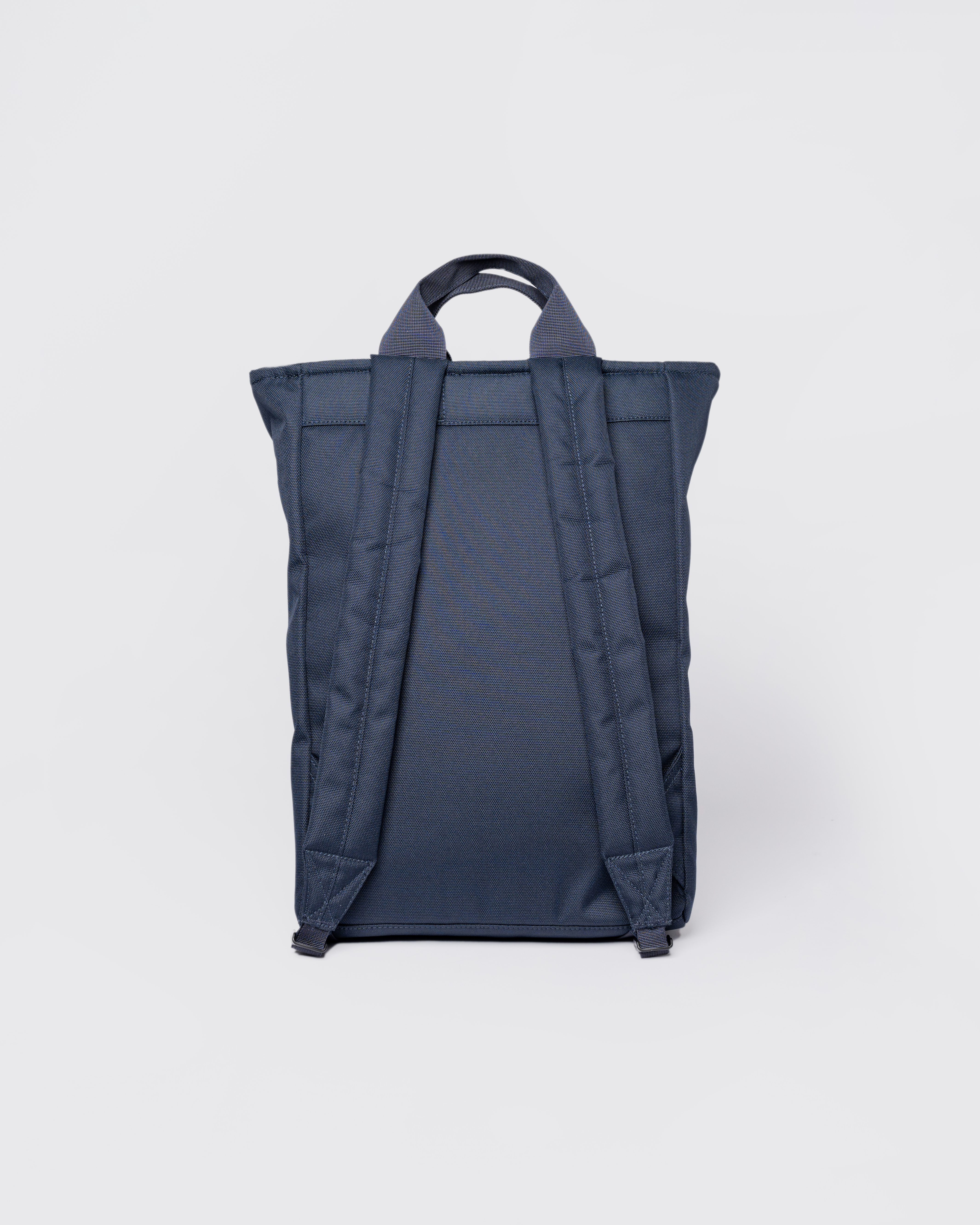 Sandqvist Ground 2-way Bag, blue. Back view, two handles and shoulder straps.