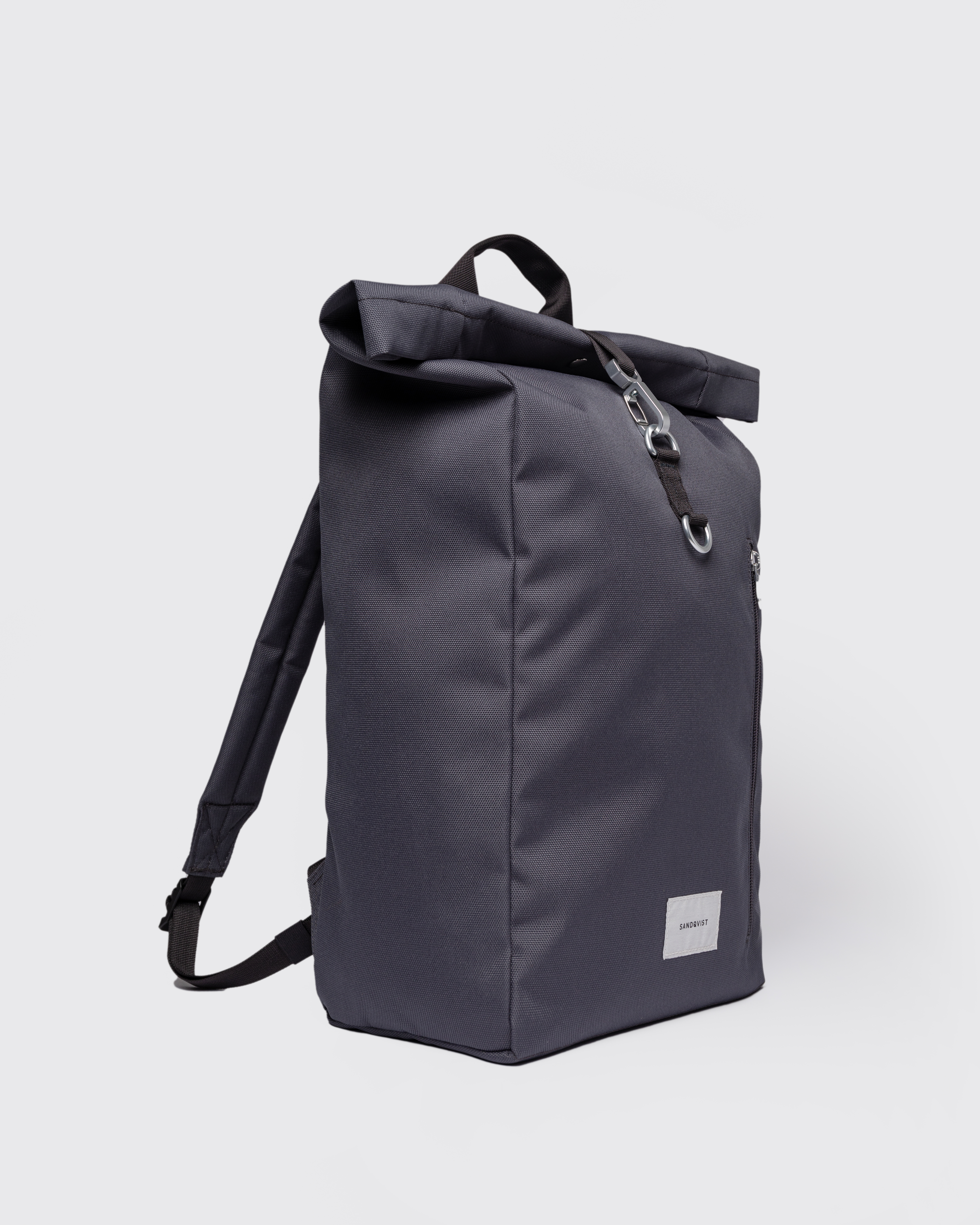 Sandqvist Ground Rolltop Backpack L, grey. Side view, front buckle, handle and shoulder strap.