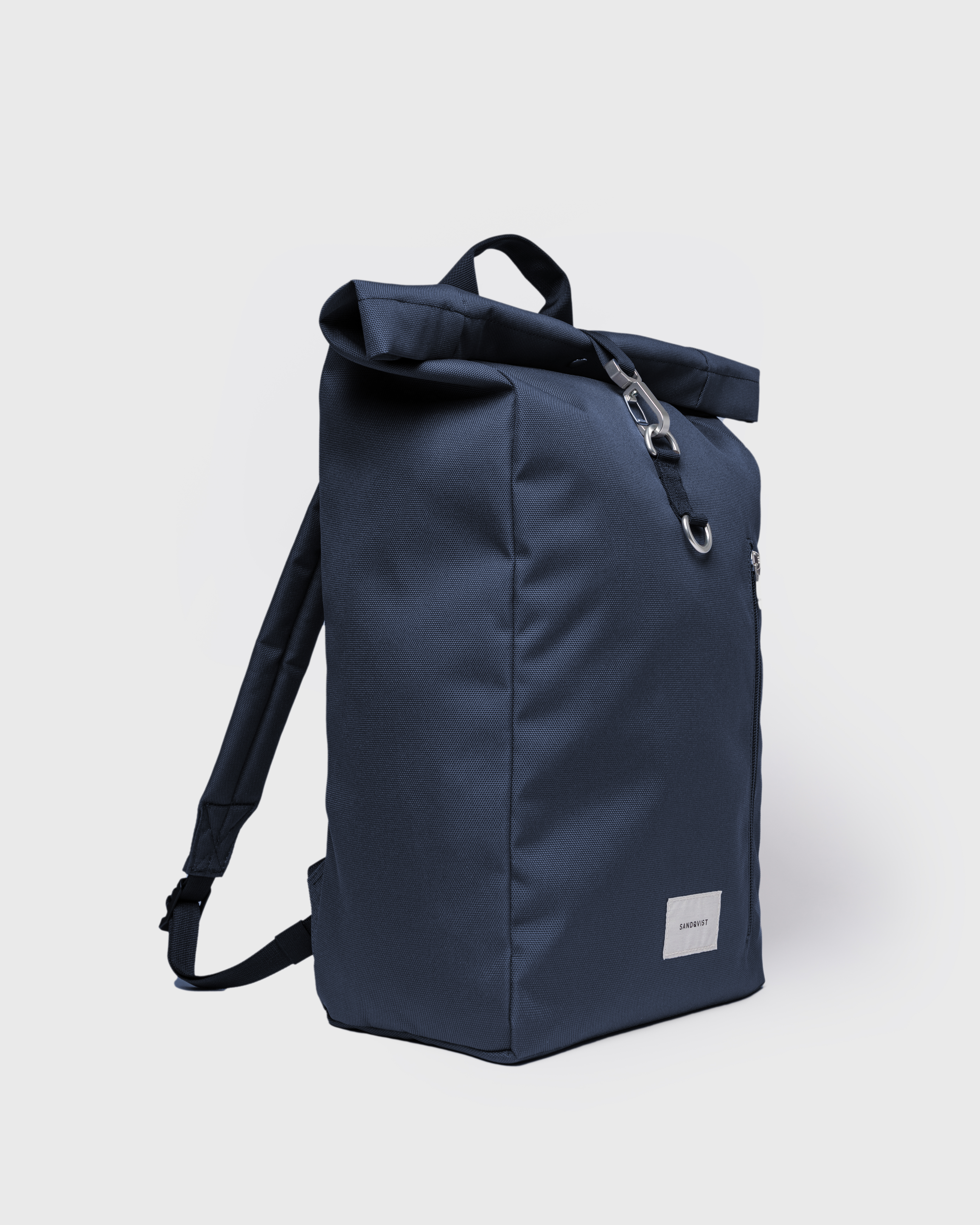 Sandqvist Ground Rolltop Backpack L, blue. Side view, handle, shoulder straps and front buckle.