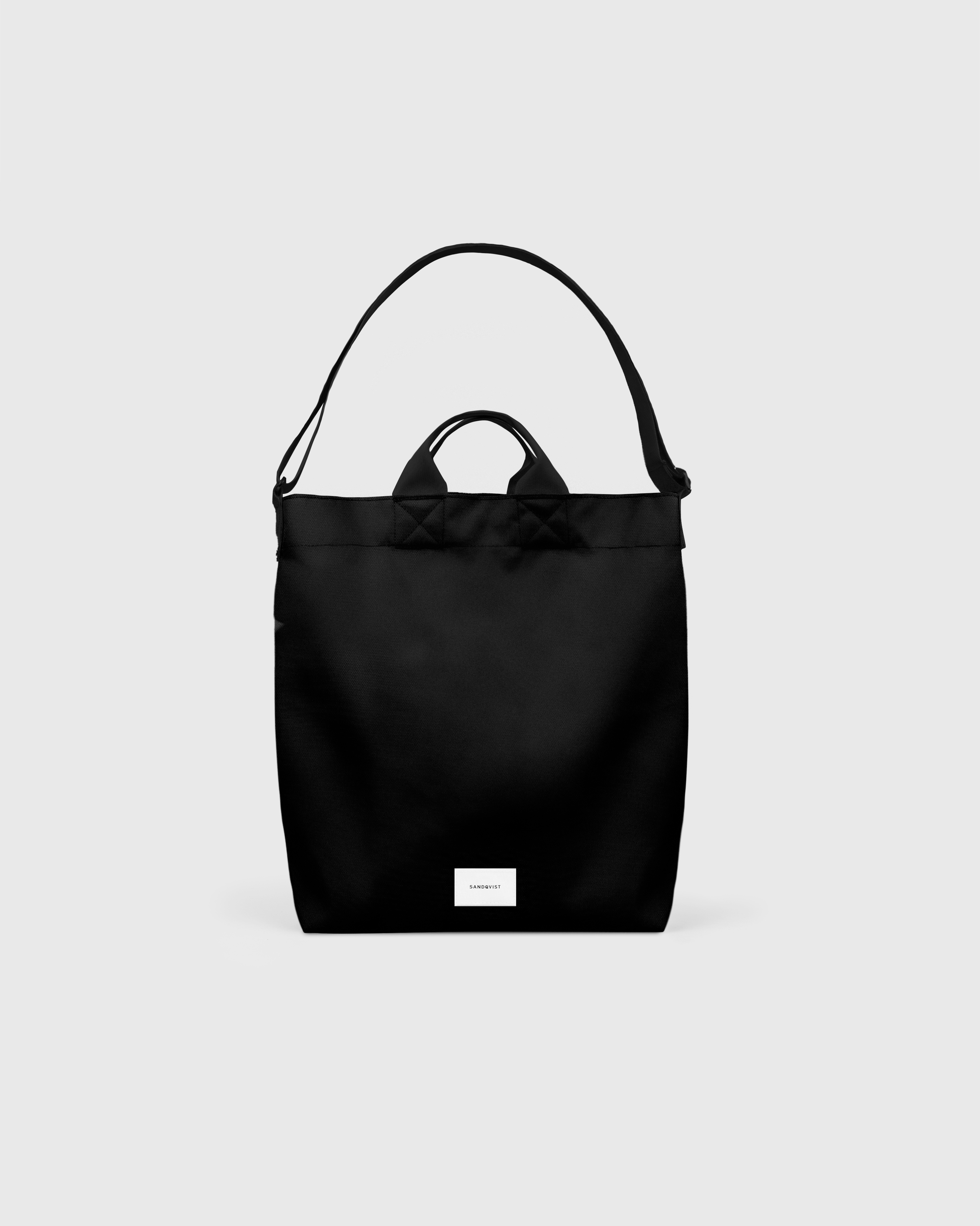 Sandqvist Ground Shopper Bag, black. Front view, handles and shoulder strap.