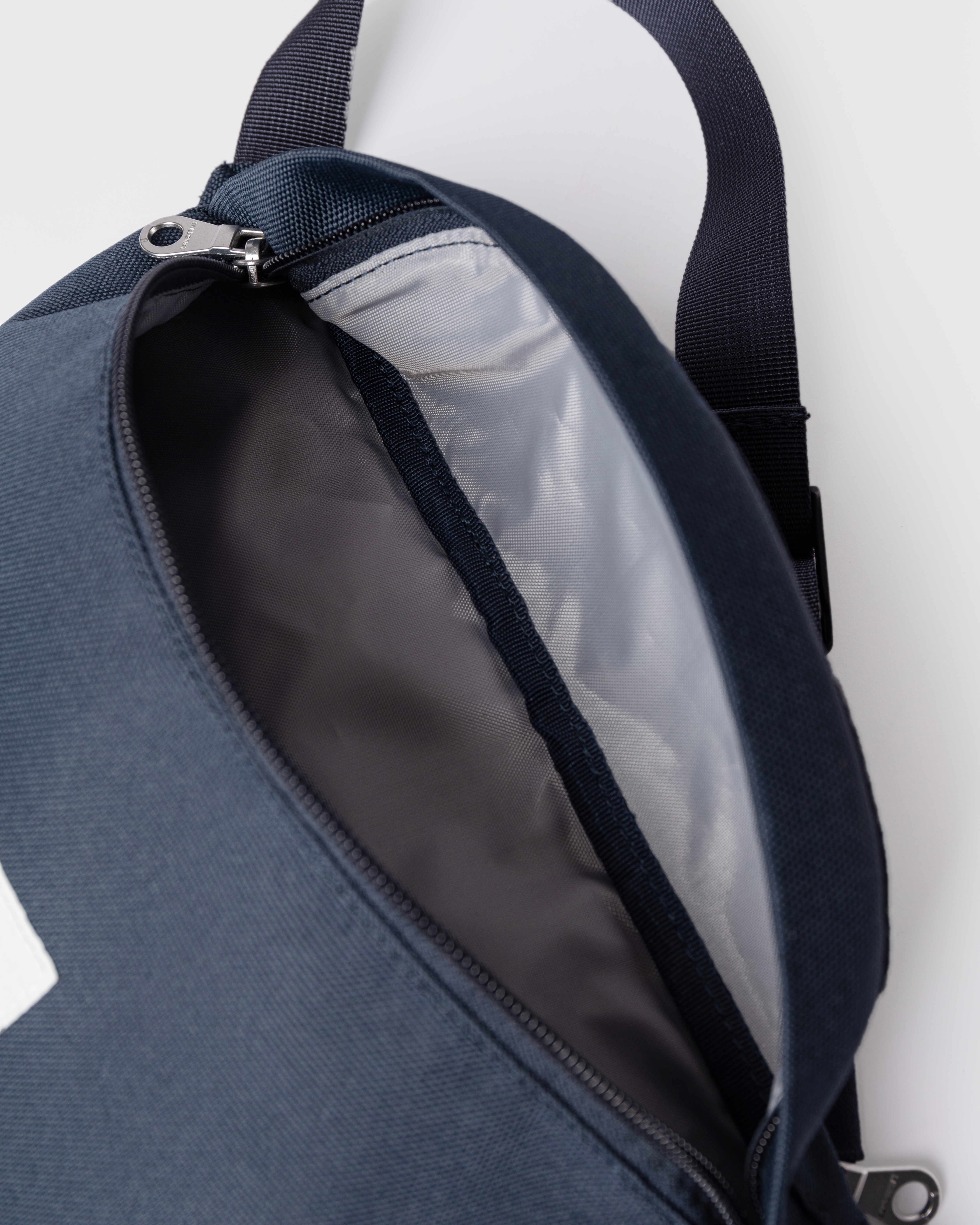 Sandqvist Ground Crossbody Bag, blue. Inside view of the main compartment.