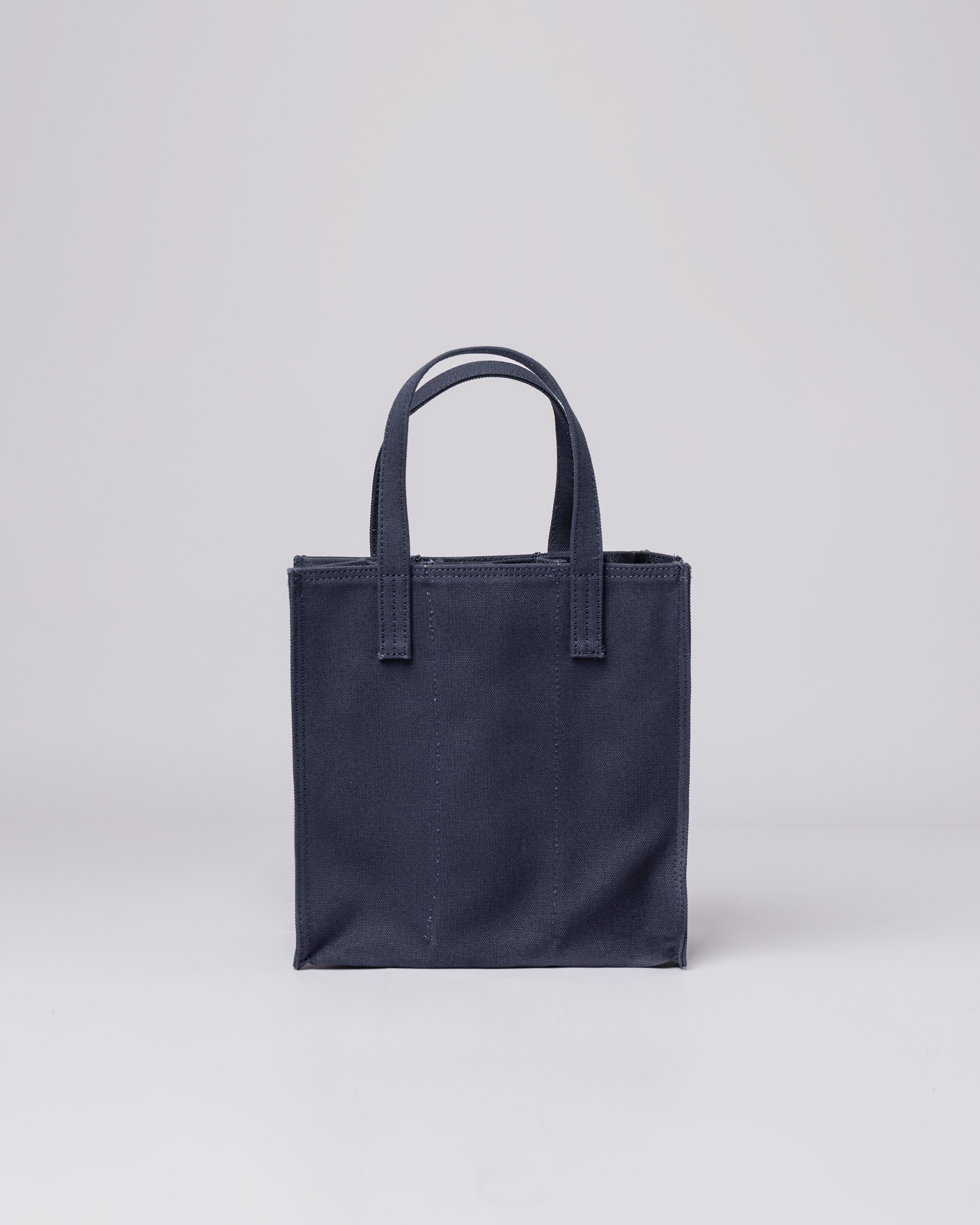 Sandqvist Bottle Bag in Navy, back view with top handles. 