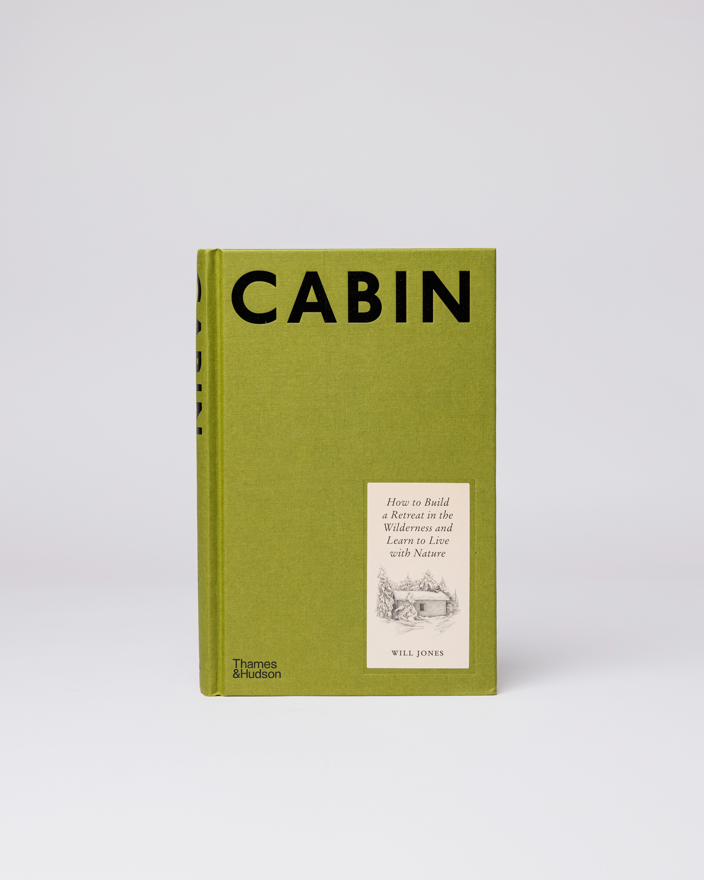 A green book with the text CABIN. Front view showing the book Sandqvist Cabin.