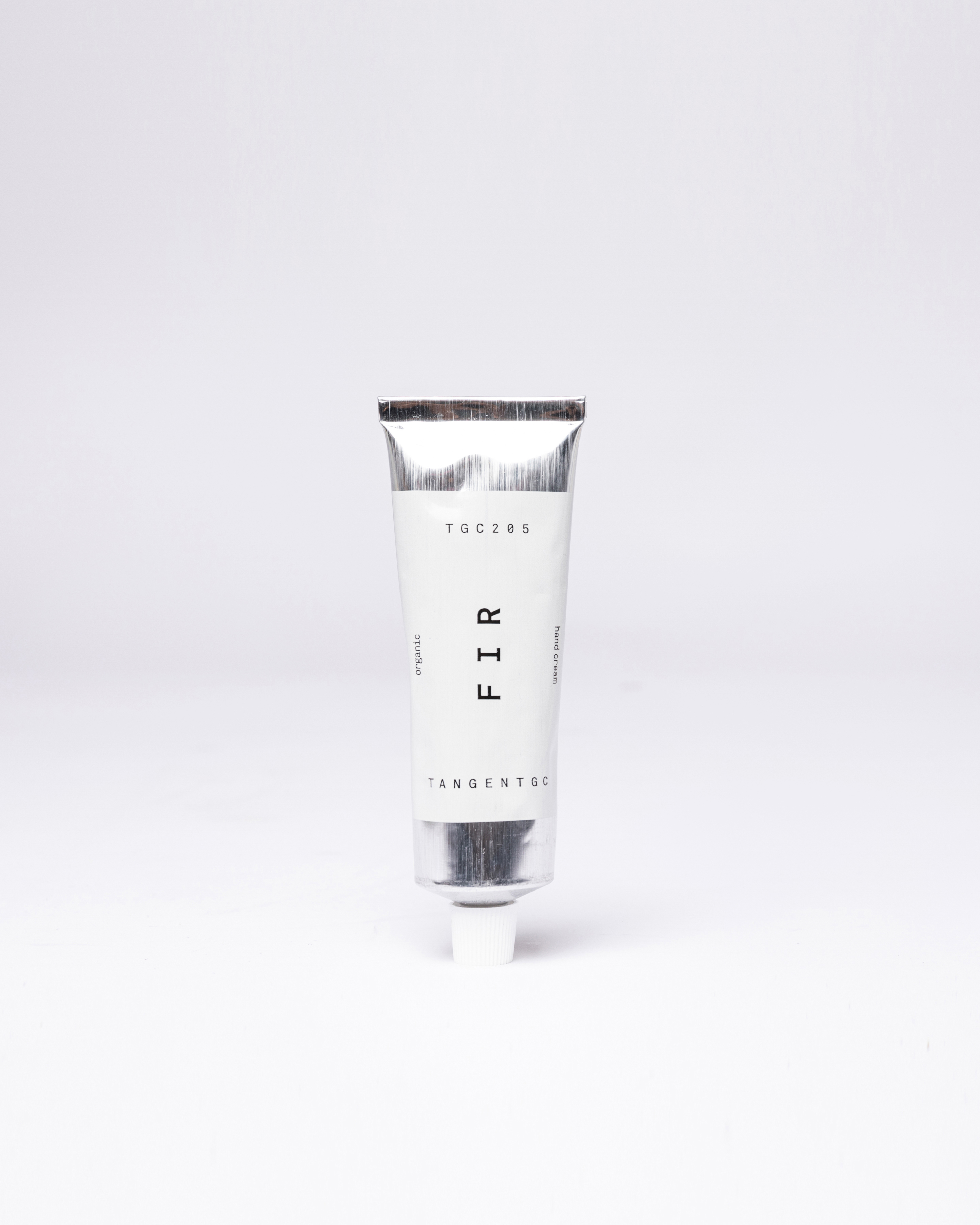 Hand cream in silver tube with white lid. Front view showing Sandqvist Fir Hand Cream.