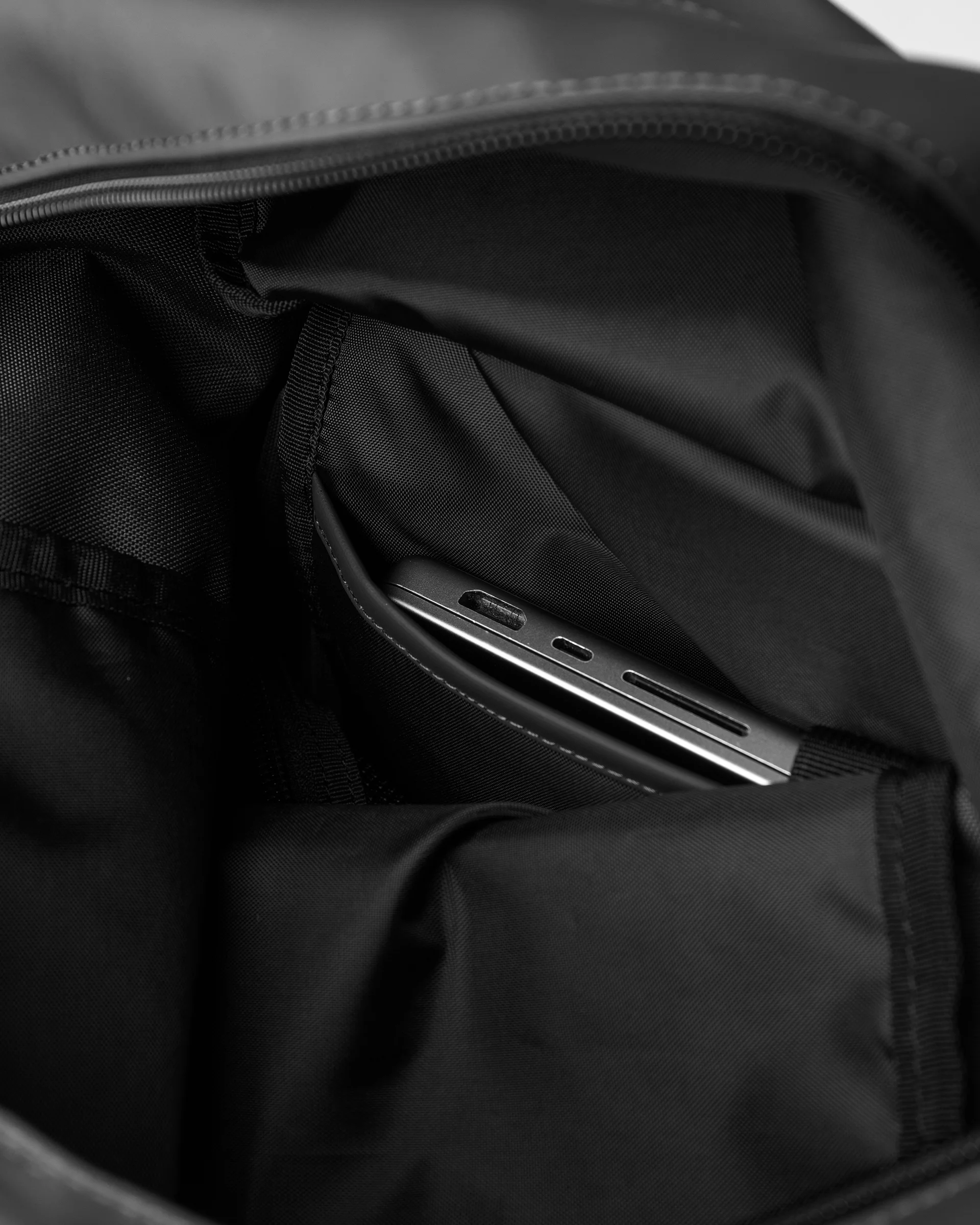 Internal laptop pocket with strap and press button on the Sandqvist backpack STREAM Rolltop Backpack L, black