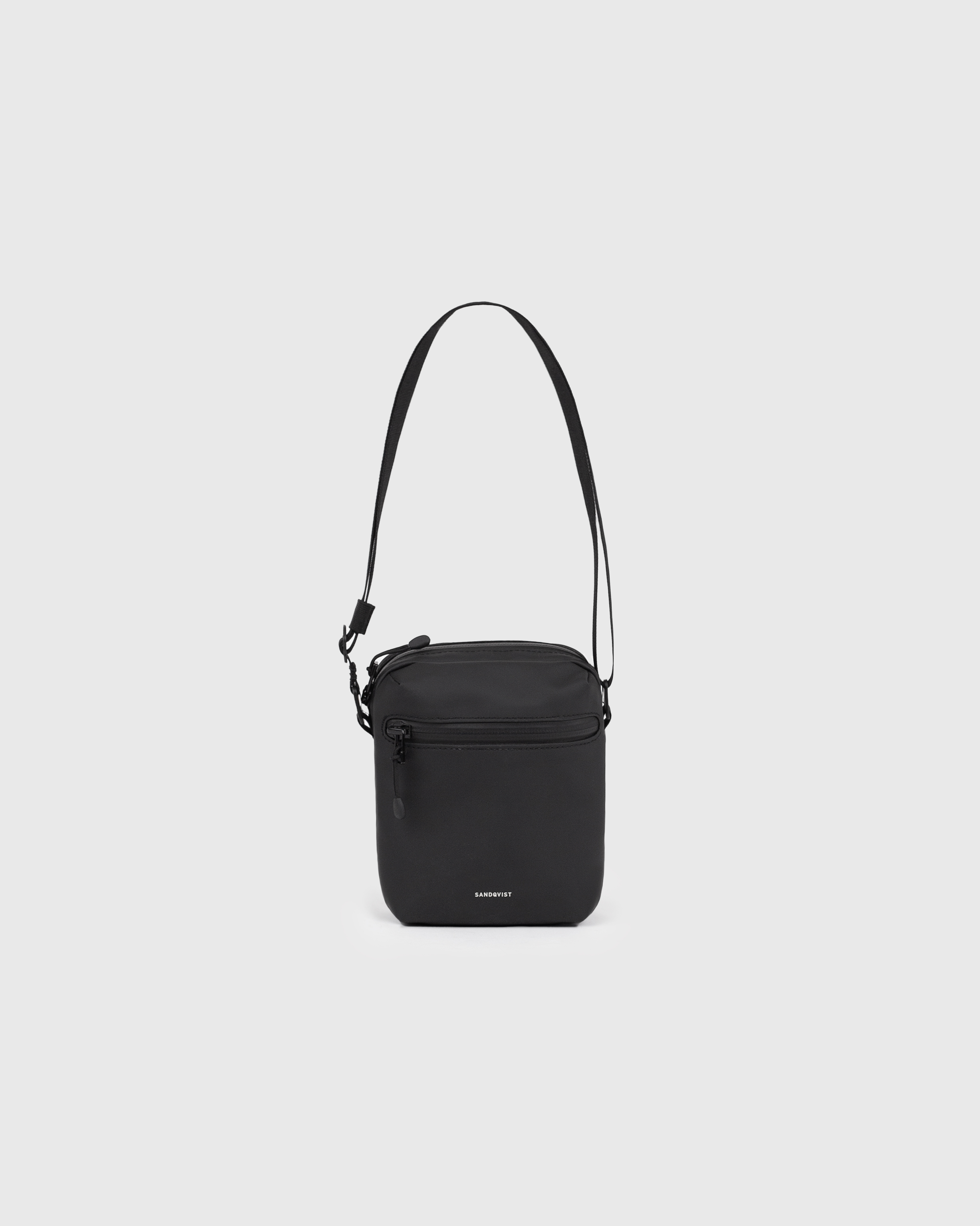 Sandqvist STREAM Shoulder Bag in black, front view with zipper pocket, adjustable shoulder strap and main compartment with zipper.
