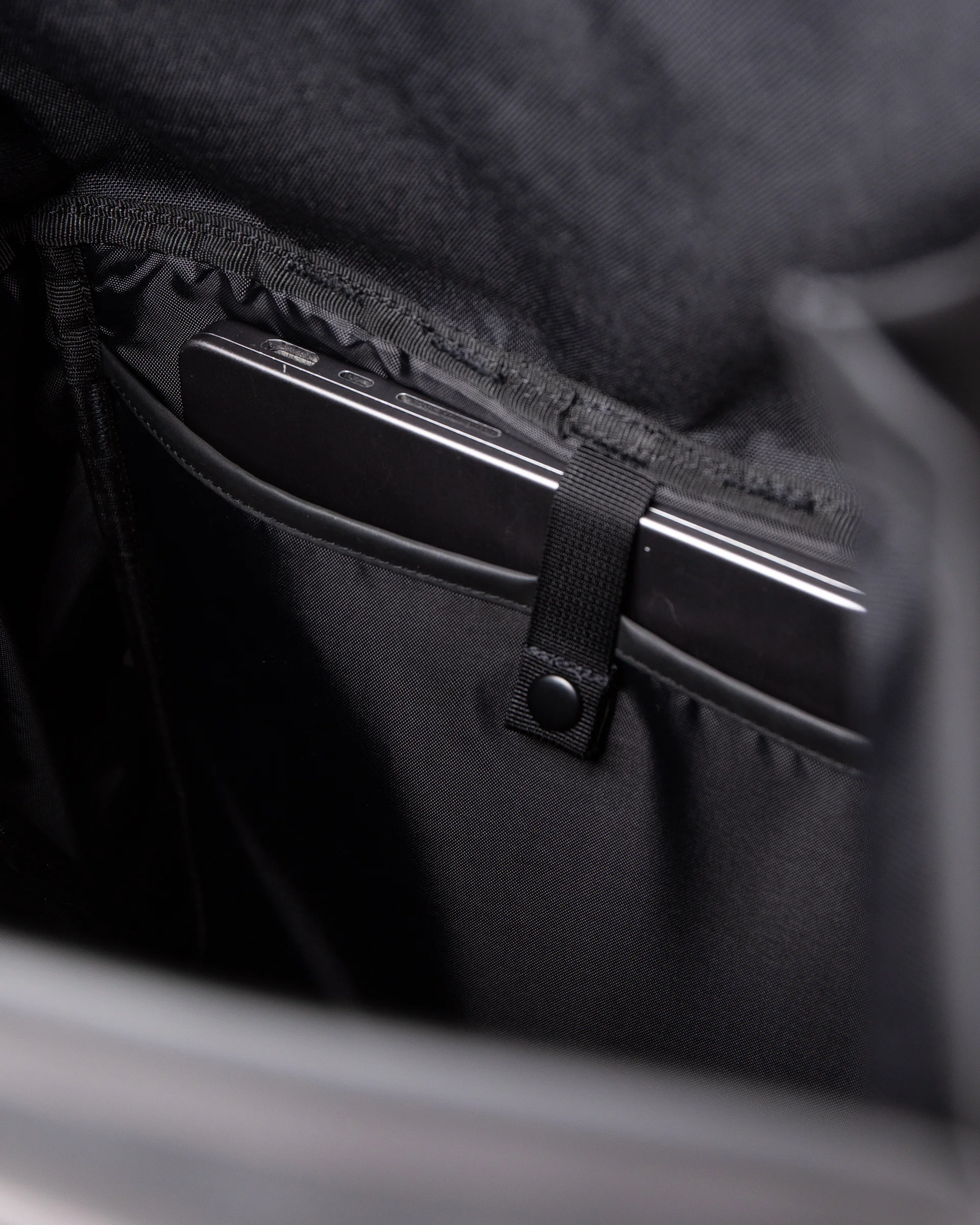 Internal laptop pocket with strap and press stud on the Sandqvist backpack STREAM Slim Rolltop L backpack, black