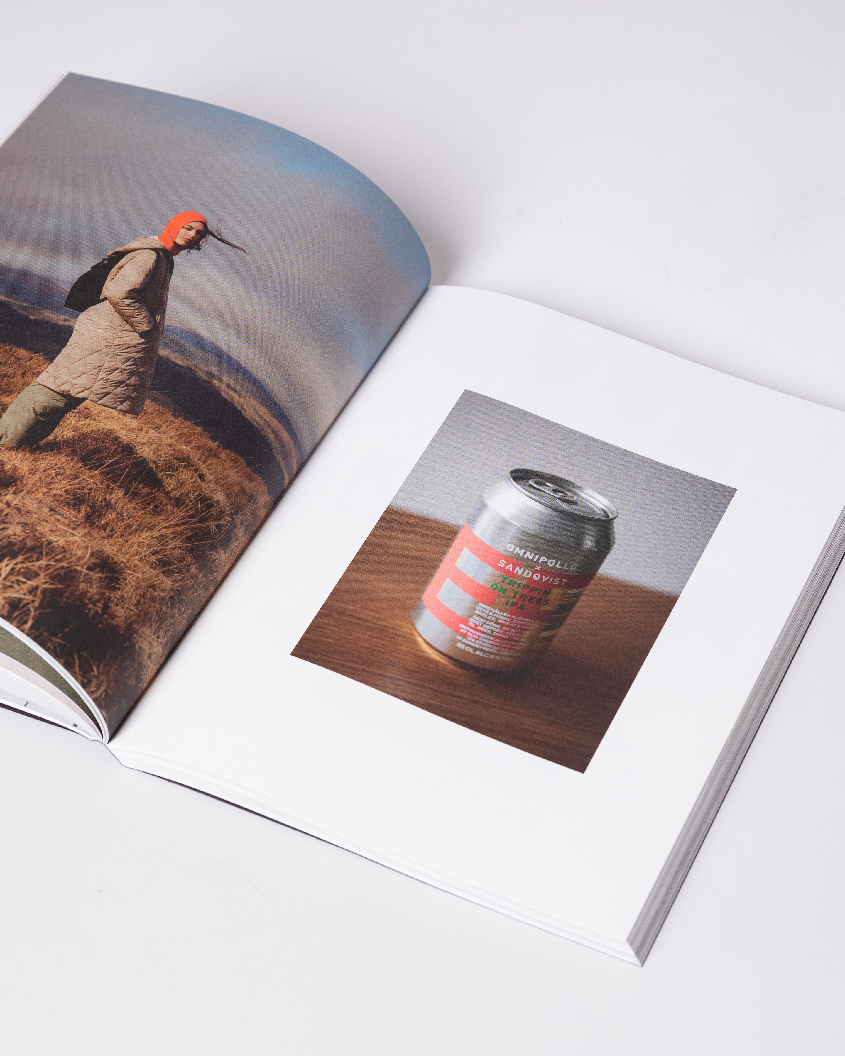 Opened book. Top view of two pages with photos from the book Sandqvist 20 years of Nordic Landscapes.