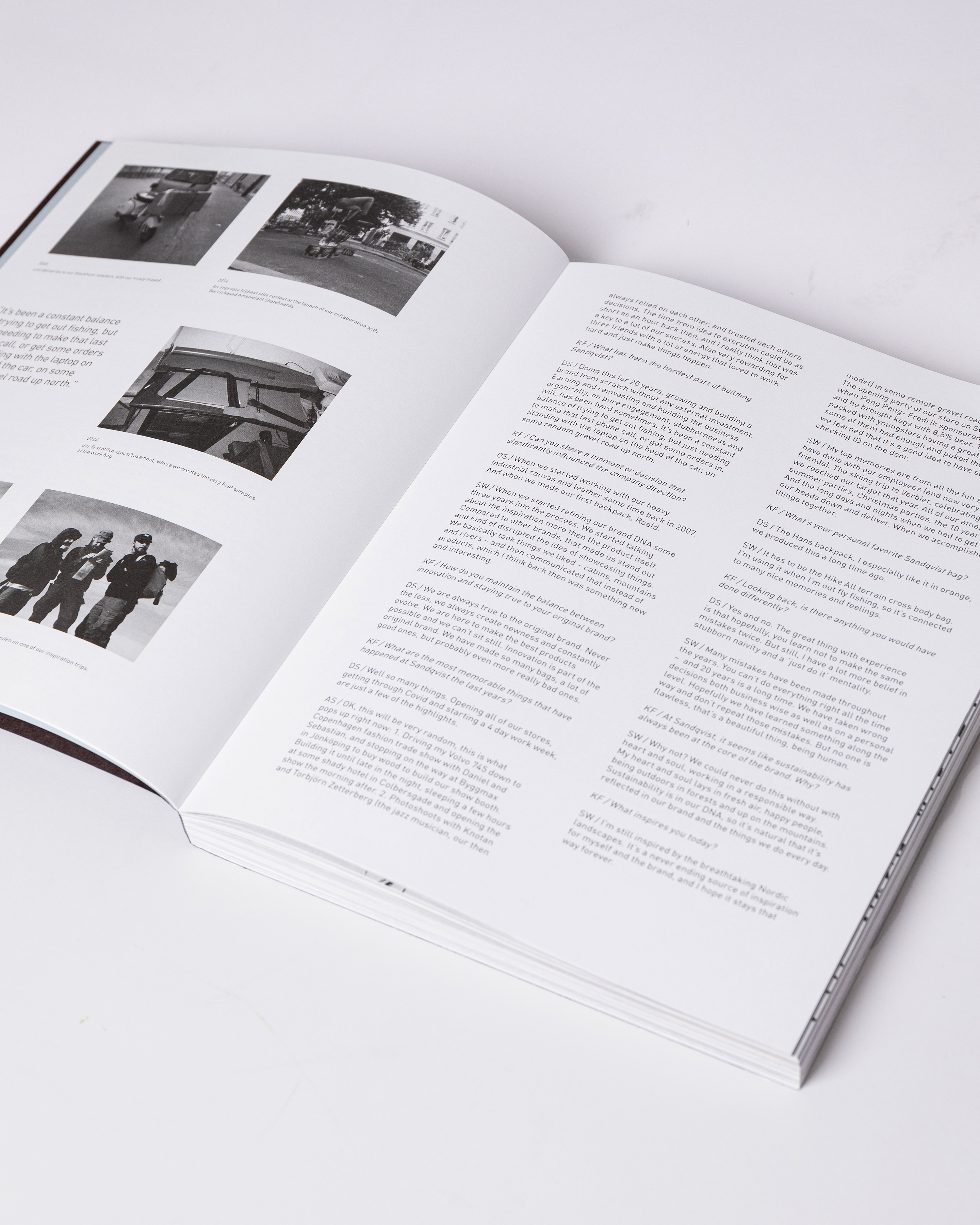 Opened book. Top view of two pages with text and photos from the book Sandqvist 20 years of Nordic Landscapes.