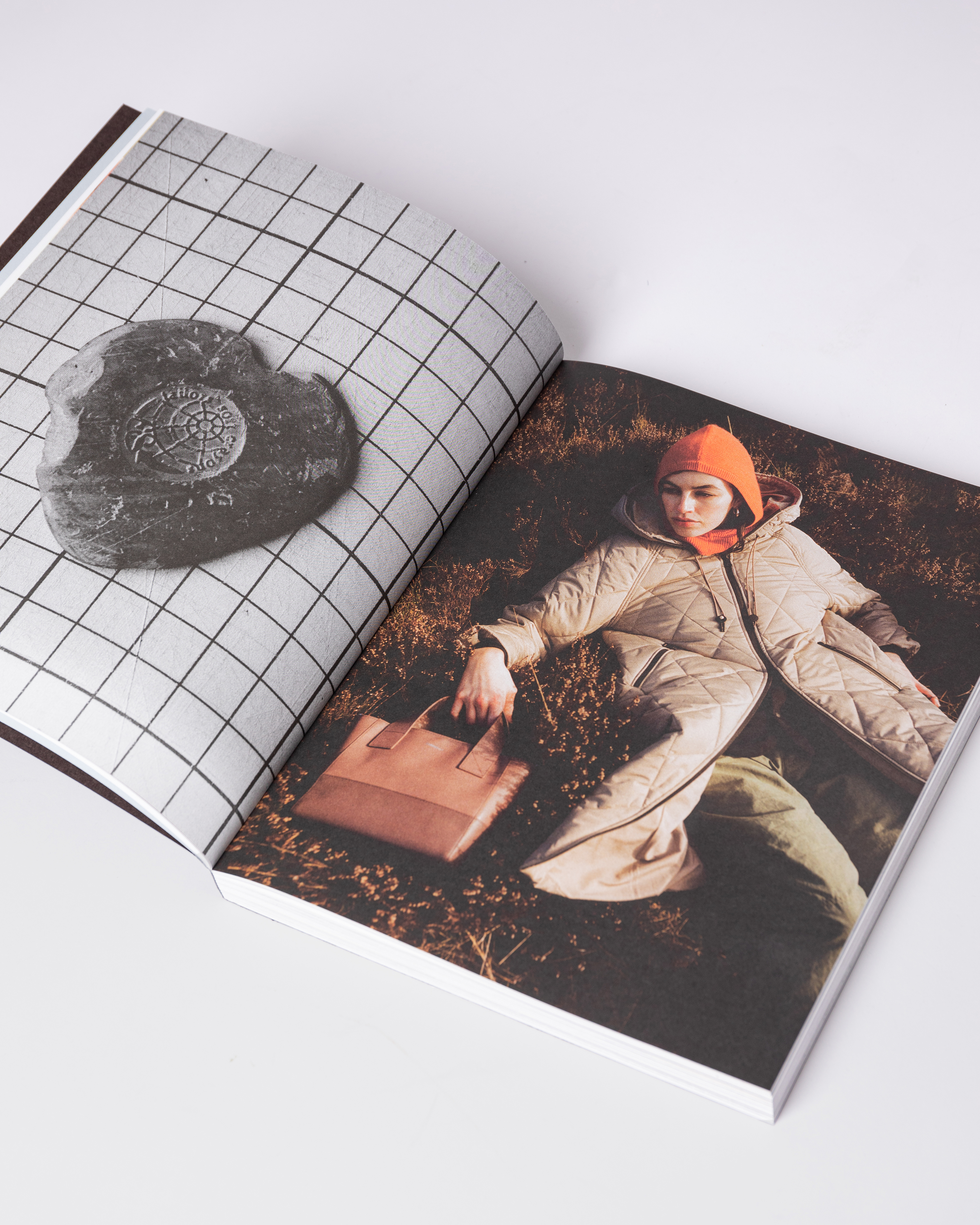 Opened book. Top view of two pages with photos from the book Sandqvist 20 years of Nordic Landscapes.