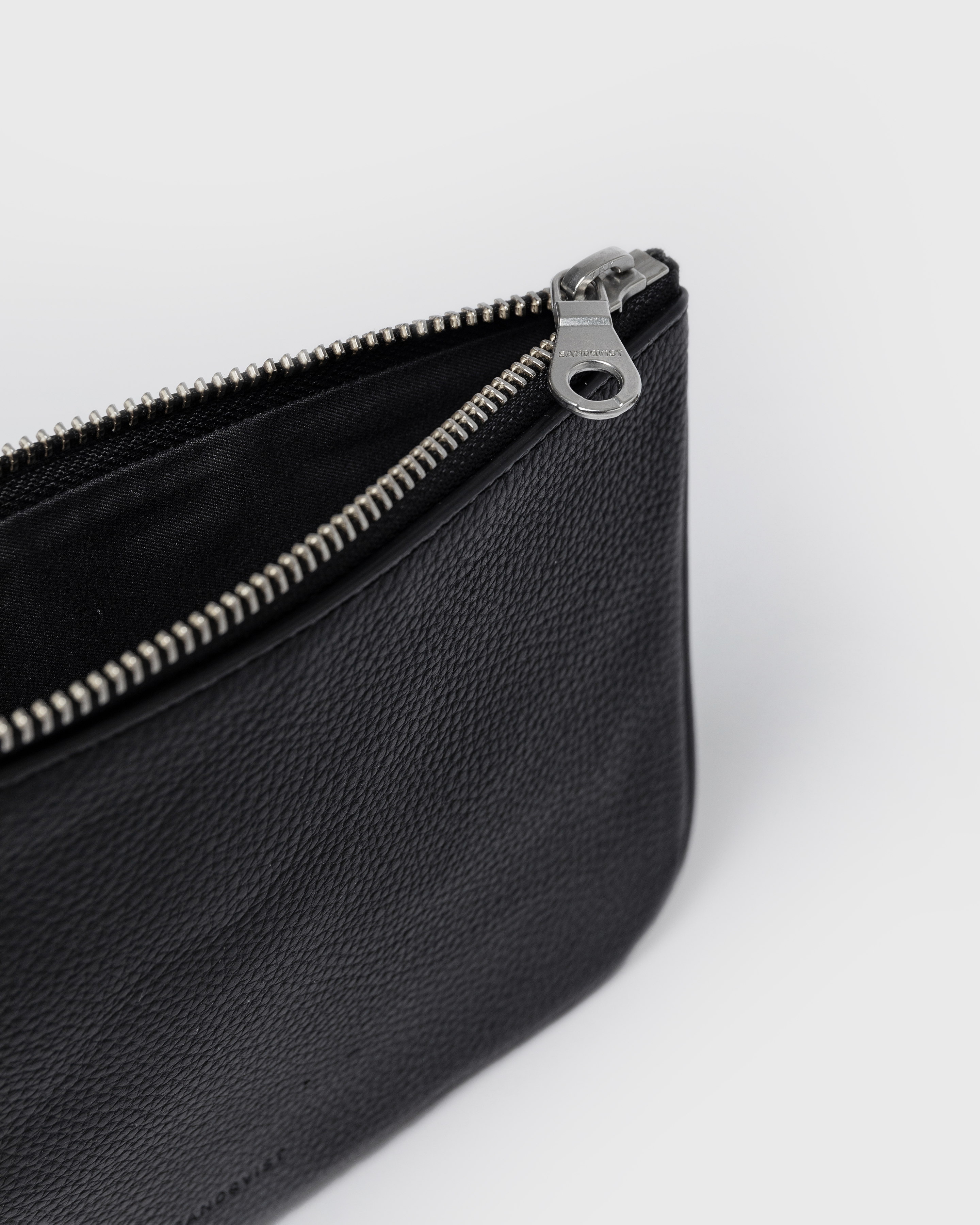 Close up view with opened zipper on main compartment on the pouch Sandqvist LEATHER Pouch.
