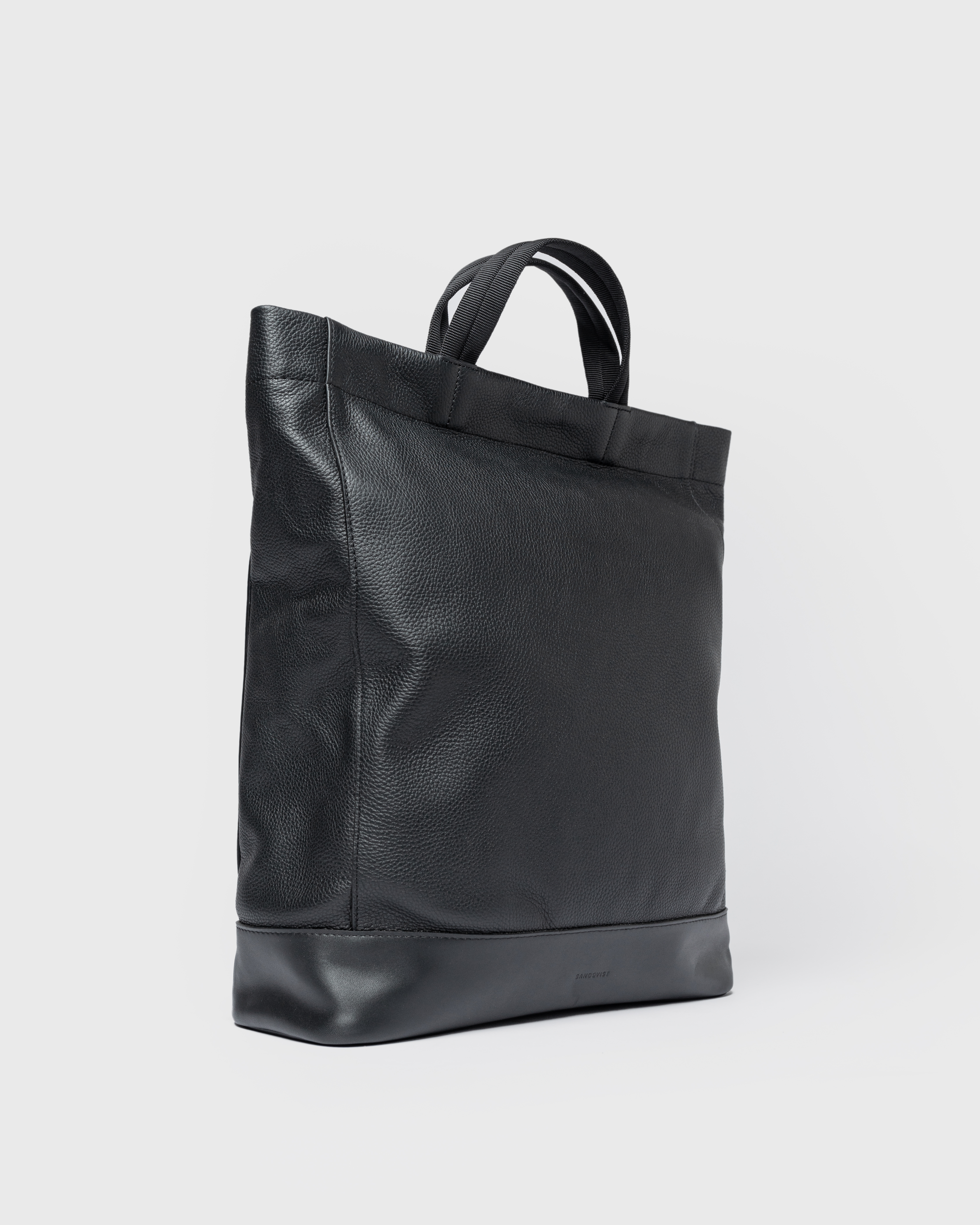 Sandqvist Backpack LEATHER Tote Backpack in black, side view view with top handles.