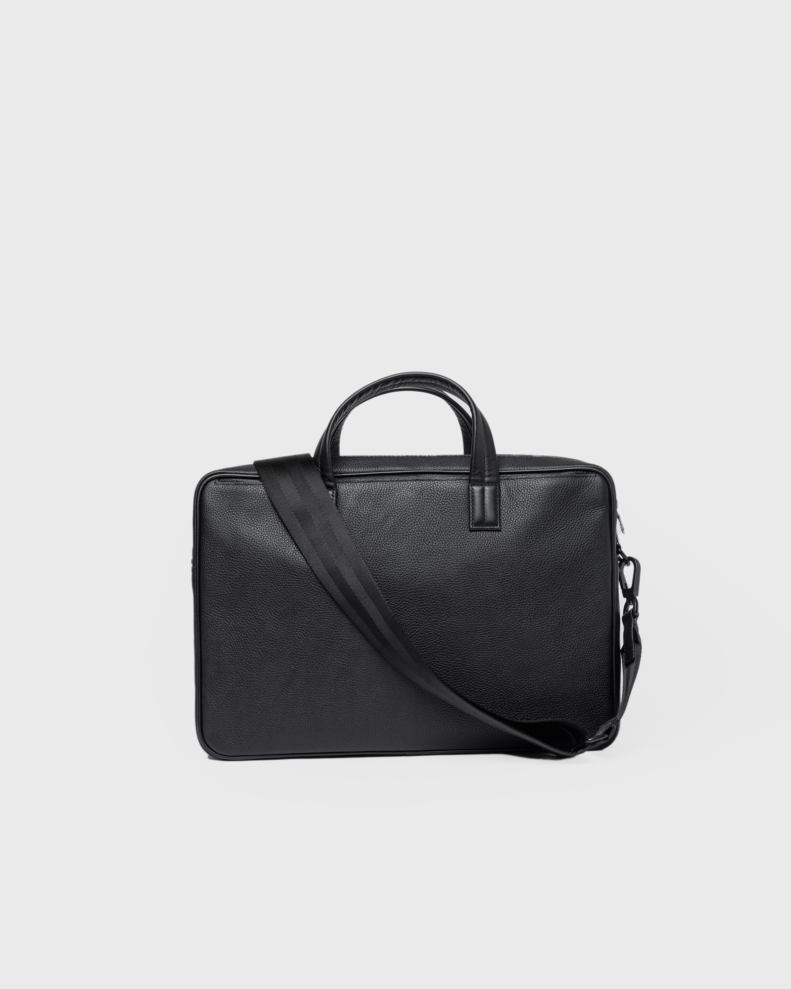 Sandqvist LEATHER Briefcase in black, back  view with top handles, shoulder strap and zipper closure.