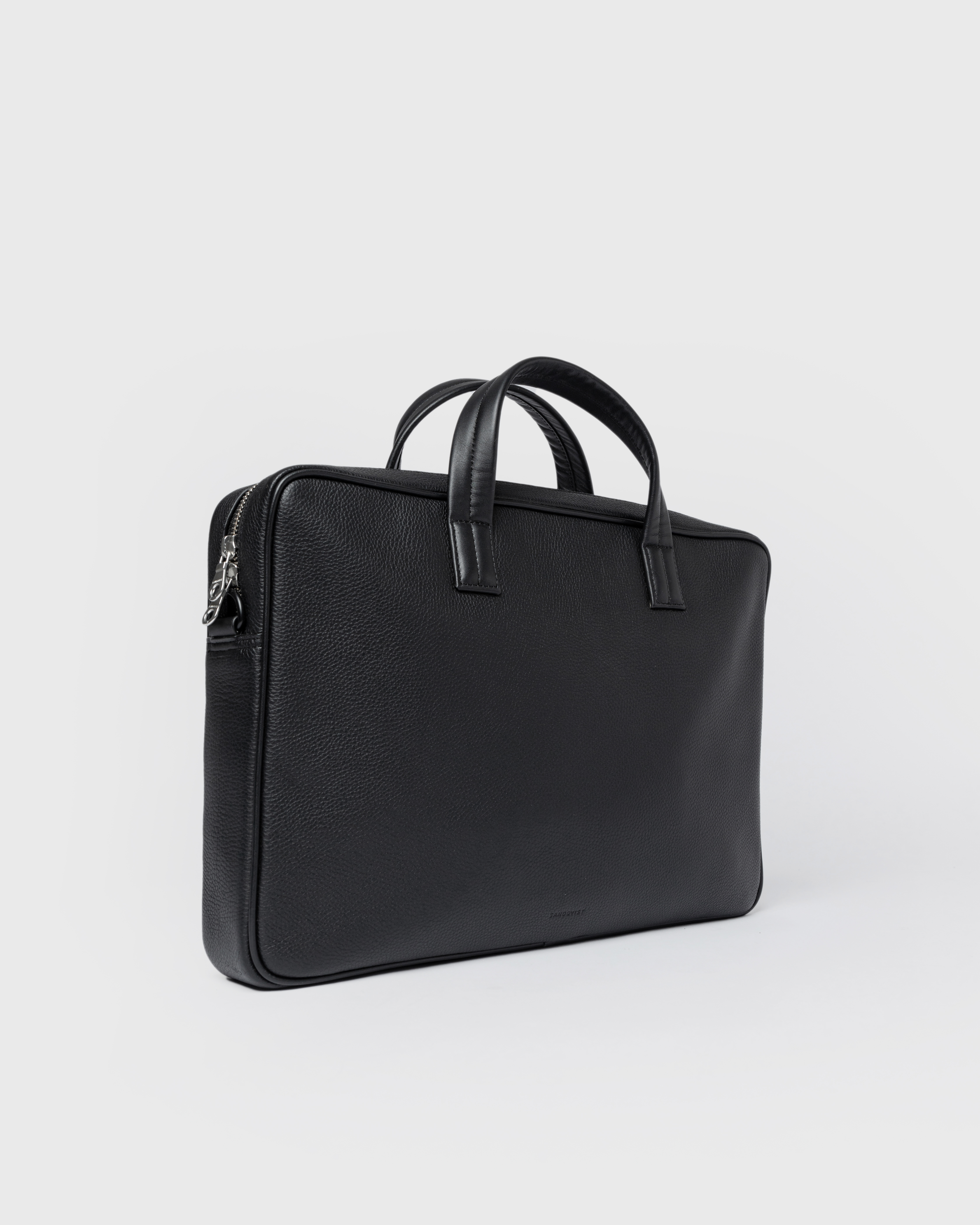 Sandqvist LEATHER Briefcase in black, side view with top handles, shoulder strap and zipper closure.