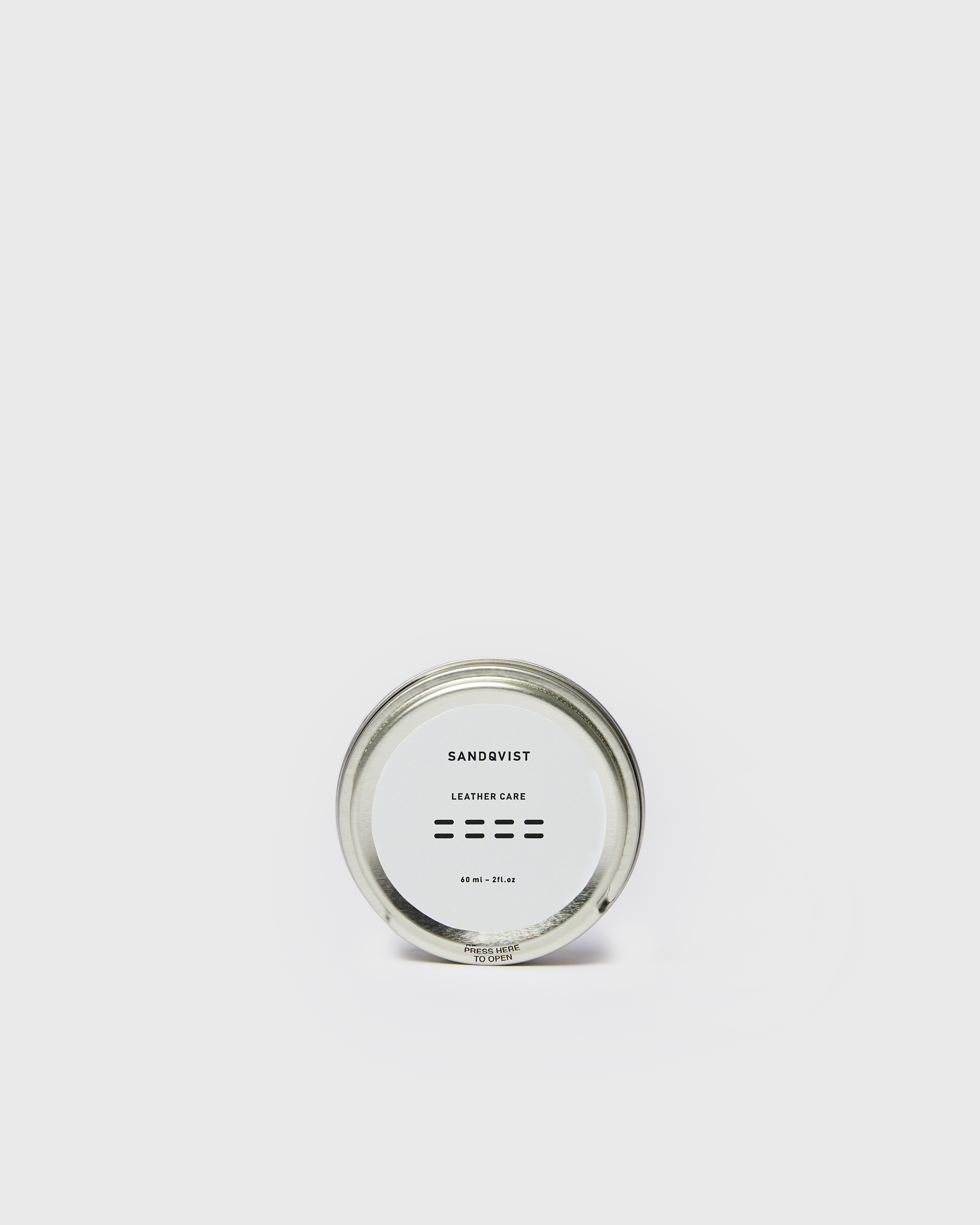 Tangent leather balm in metal can with Sandqvist logo.