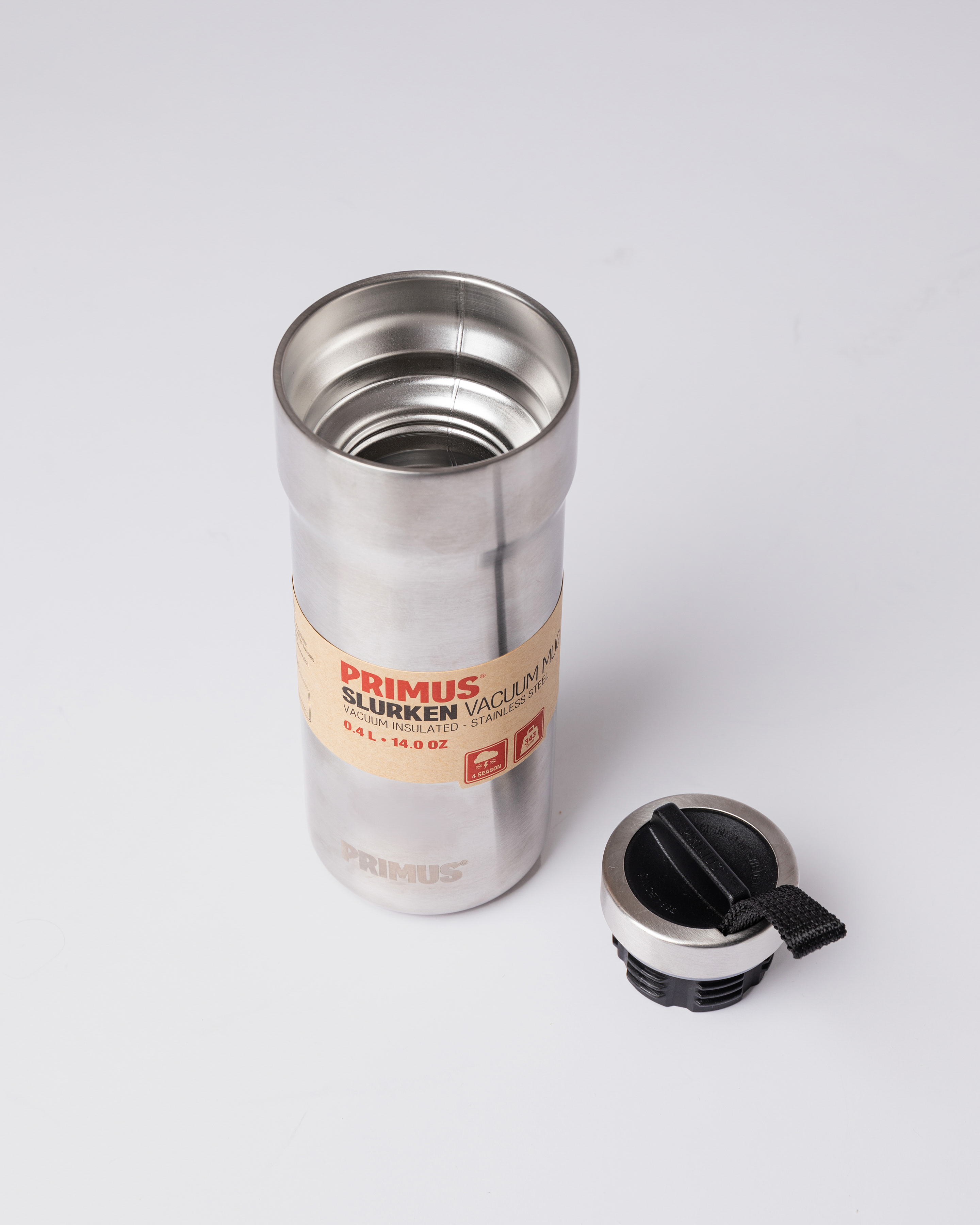 Metal Mug in silver with black lid. Front top view showing Sandqvist Slurken Vacuum Mug 0.4L opened with the lid on the side.