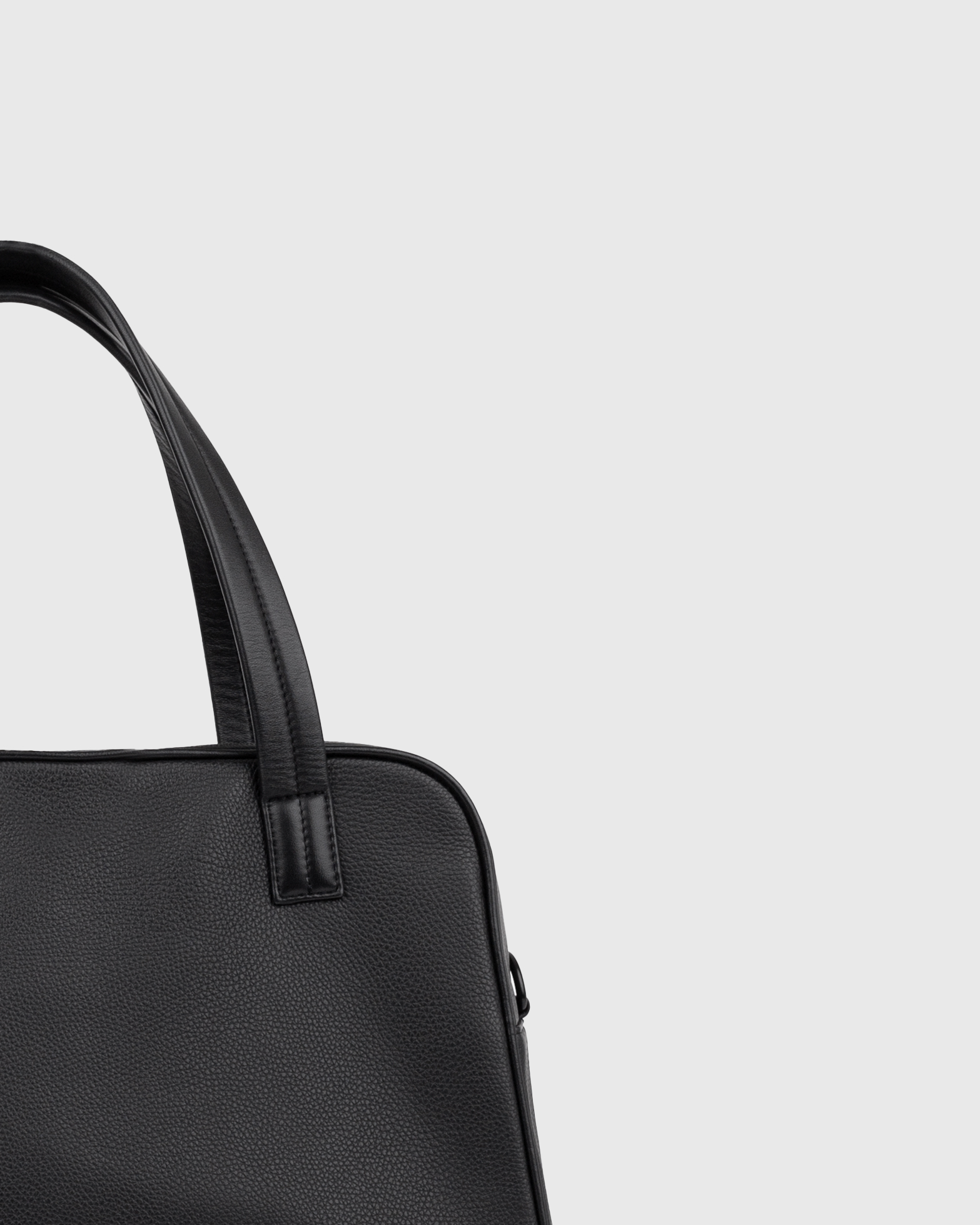Close up view of the leather handbag Sandqvist LEATHER Bowling Bag in black, showing the handles.