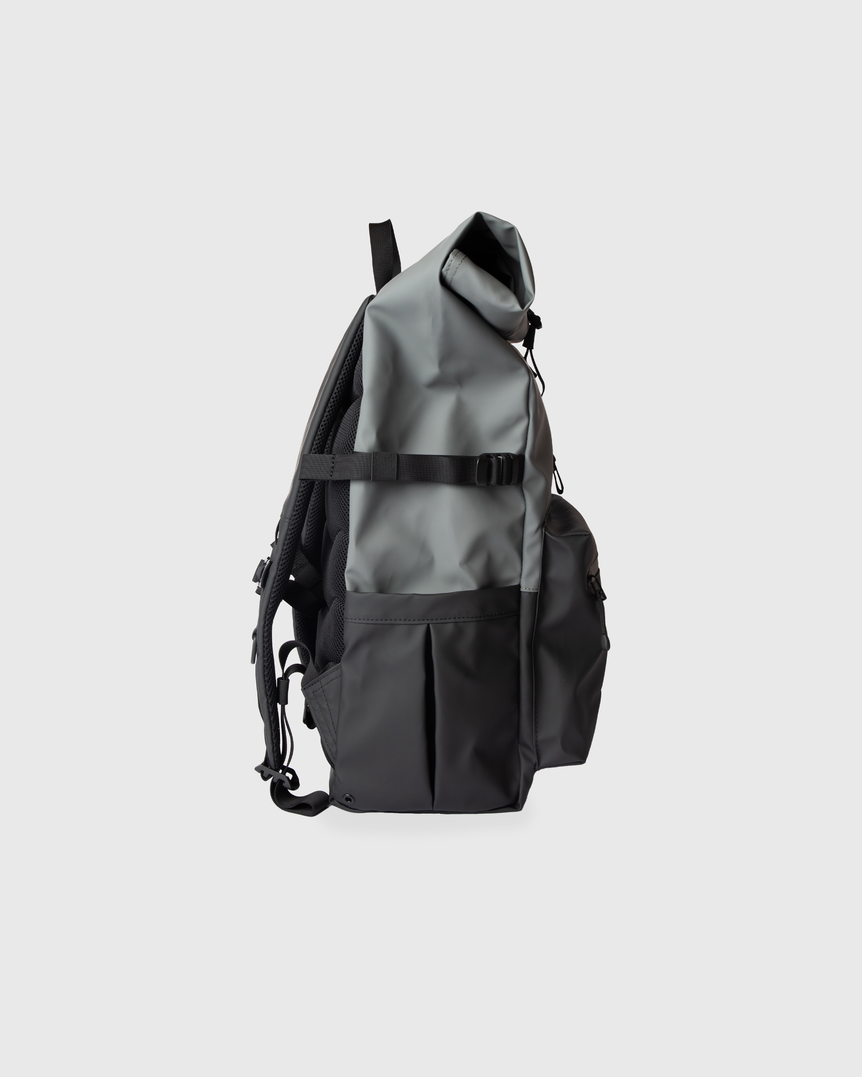 Backpack. Sandqvist STREAM Rolltop backpack L in Grey and black, side view with, top handle, pocket at front, slip pocket, side strap and rolltop closure.