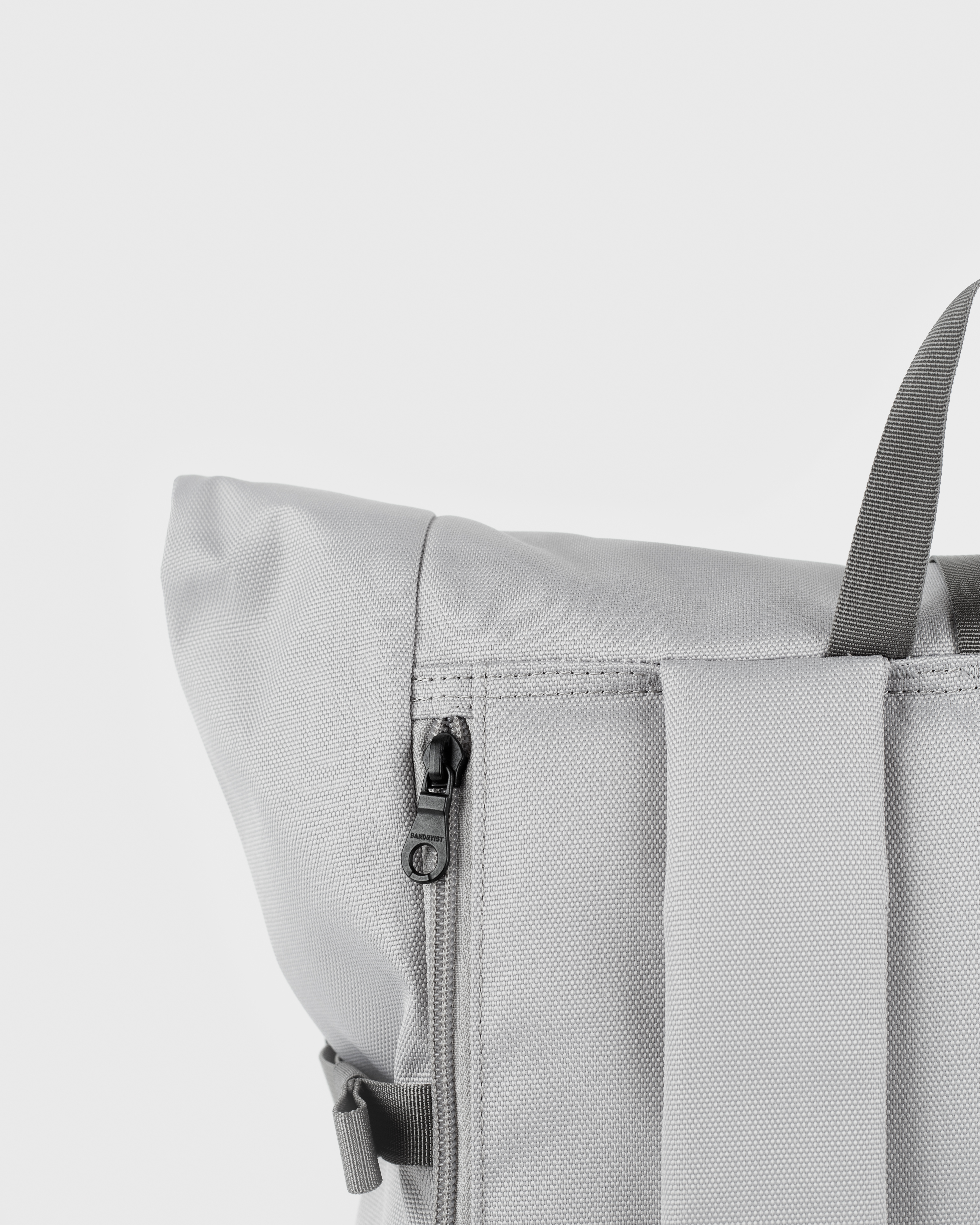 Sandqvist Icon Rolltop Backpack L 16, grey. Close-up of the zipper of the laptop compartment.